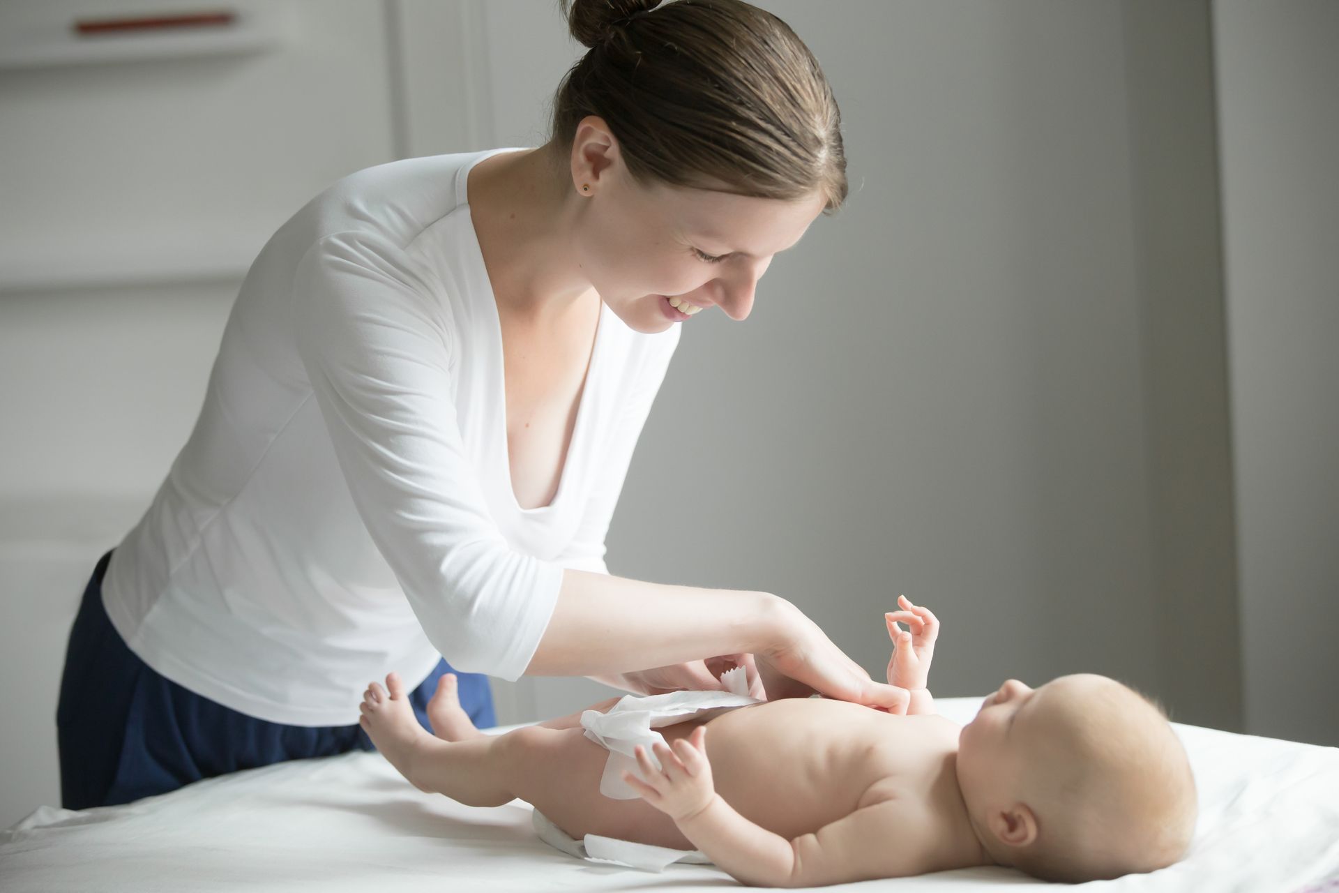 A woman changing a baby's diaper