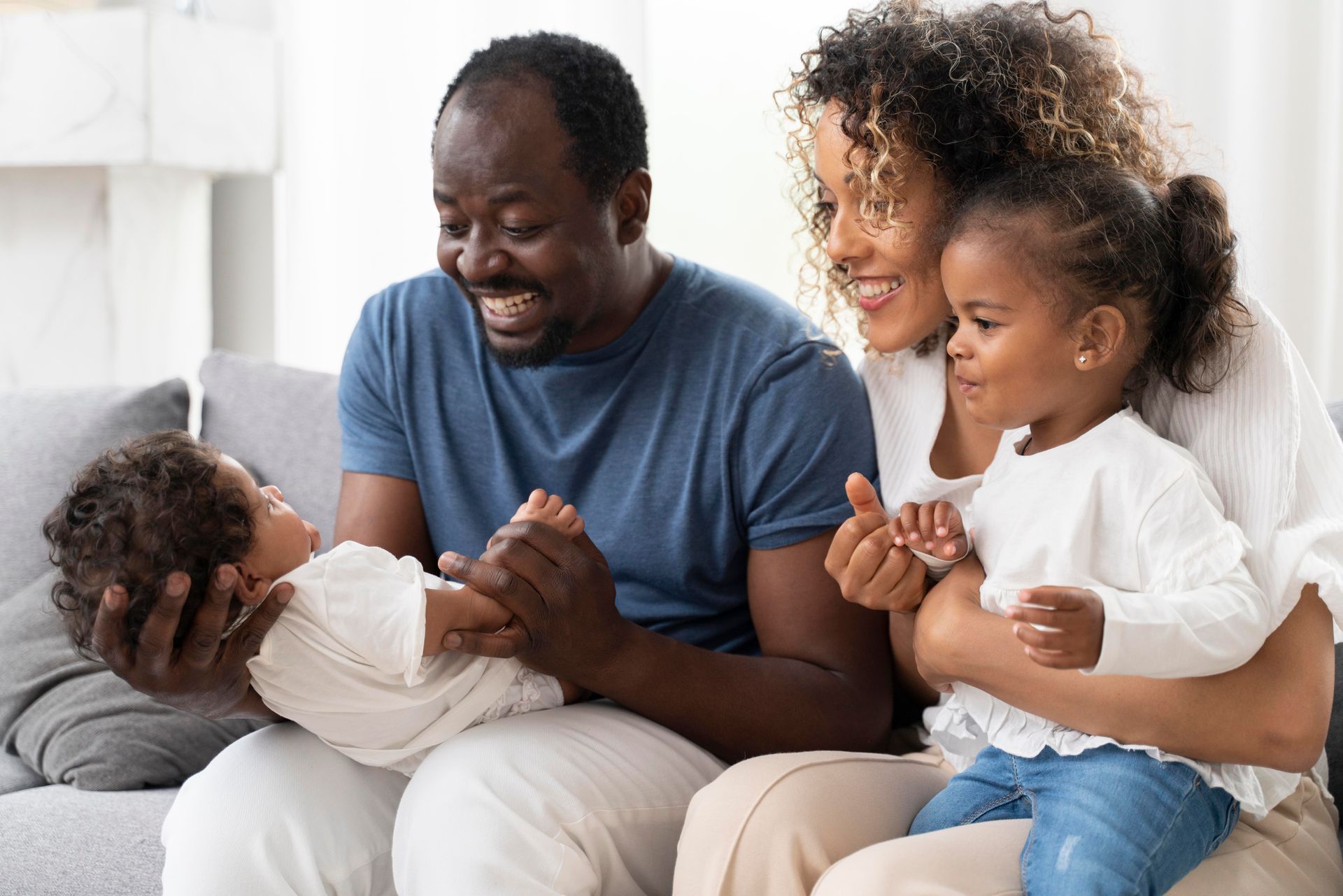 a mom and dad with their toddler and newborn