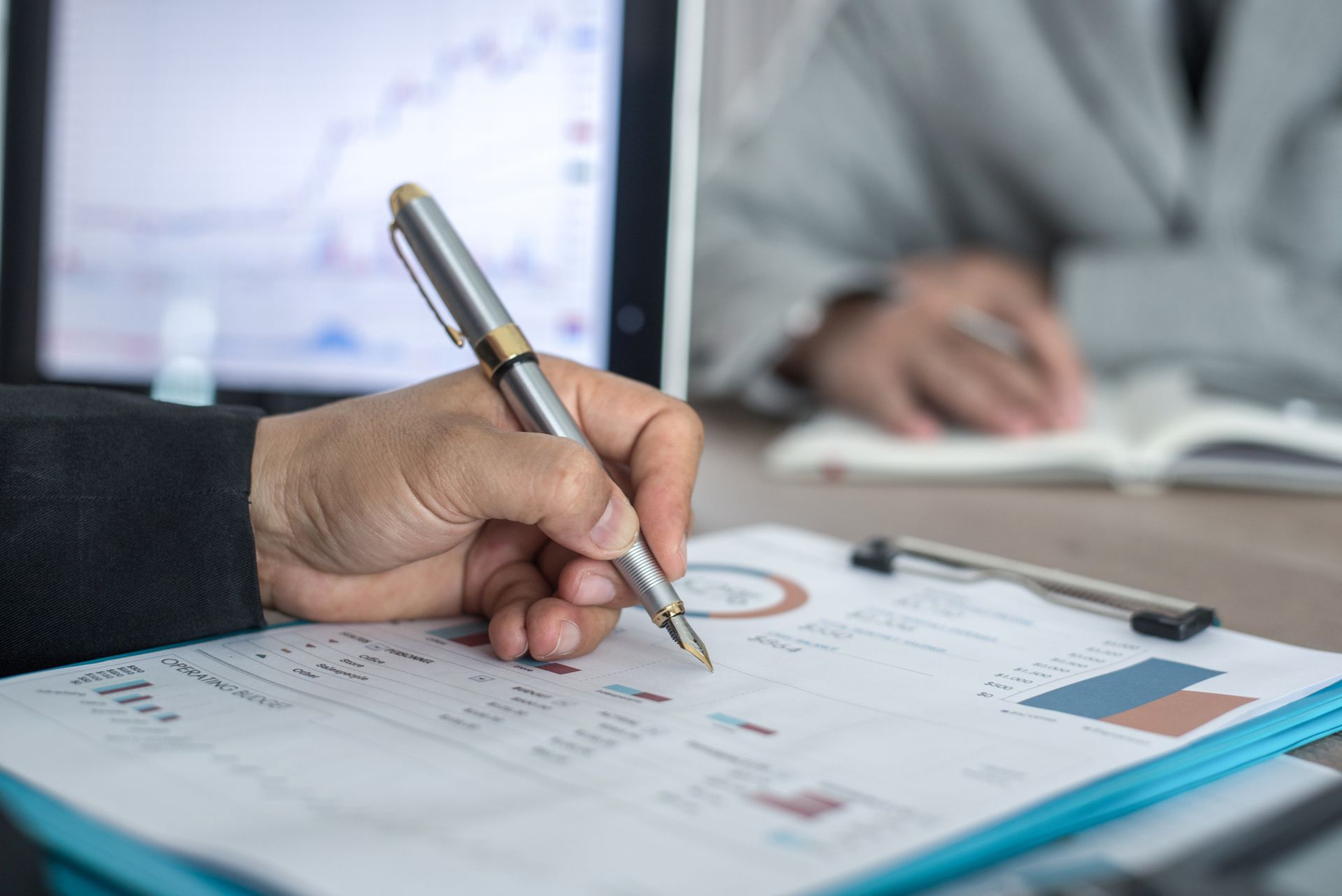 Accountants reviewing a business's financial statements for accurate tax preparation.