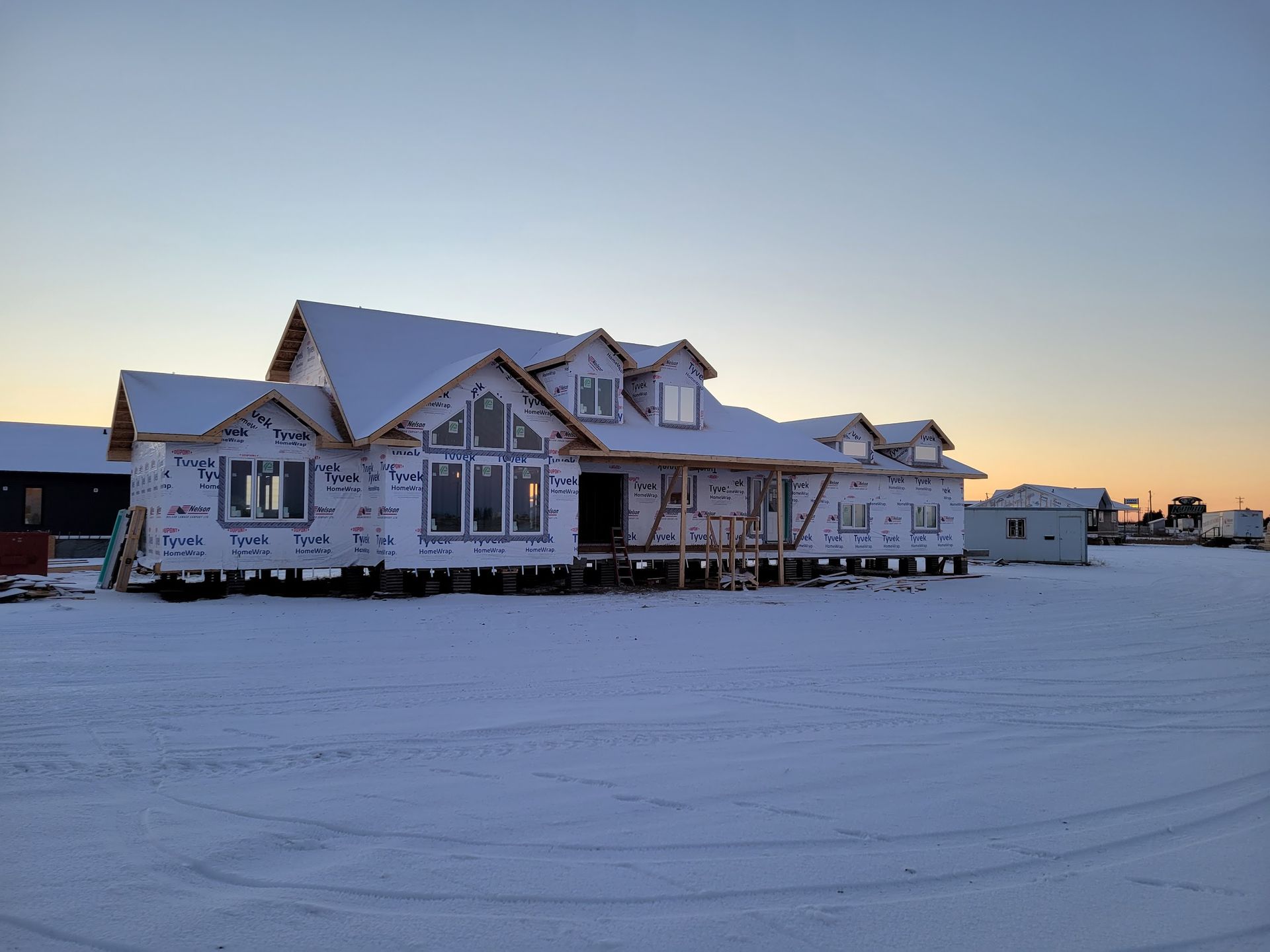 A large house is being built in the snow.