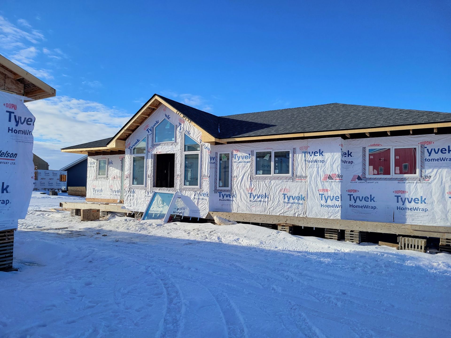 A house is being built in the snow and is covered in styrofoam.