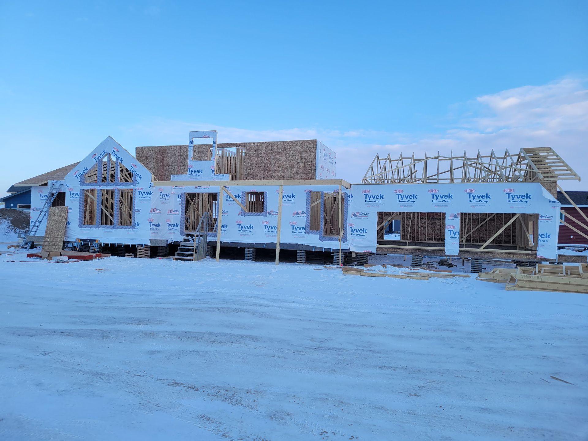 A large house is being built in the snow.