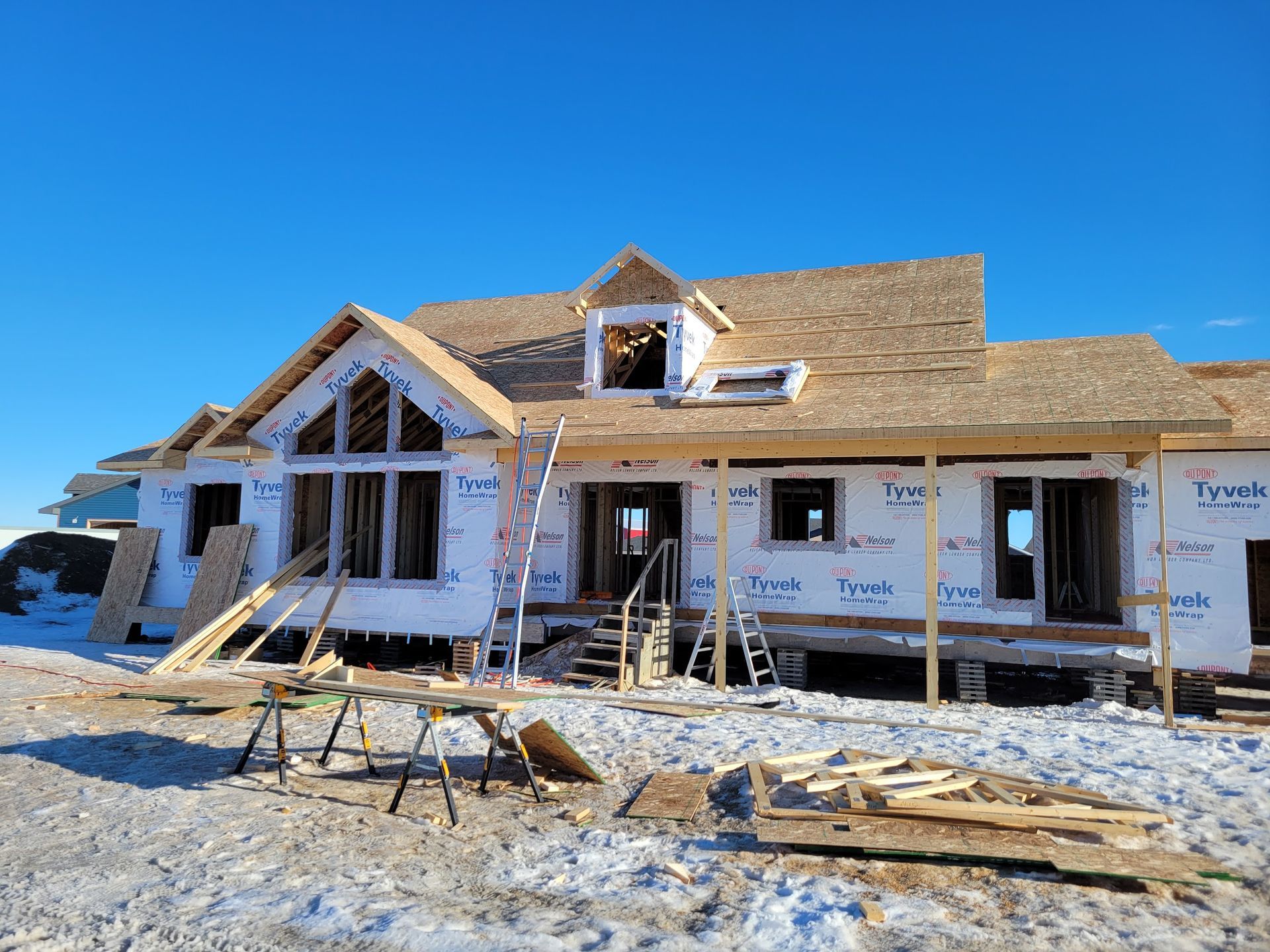 A large house is being built in the snow.