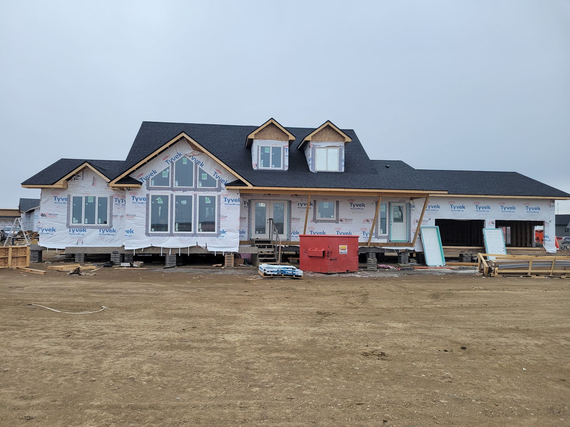 A large house is being built in a field.