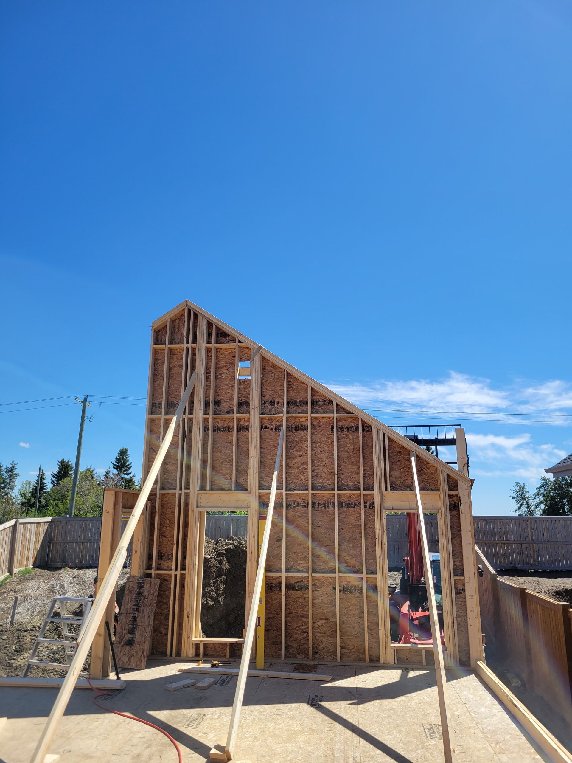 A house is being built with a blue sky in the background