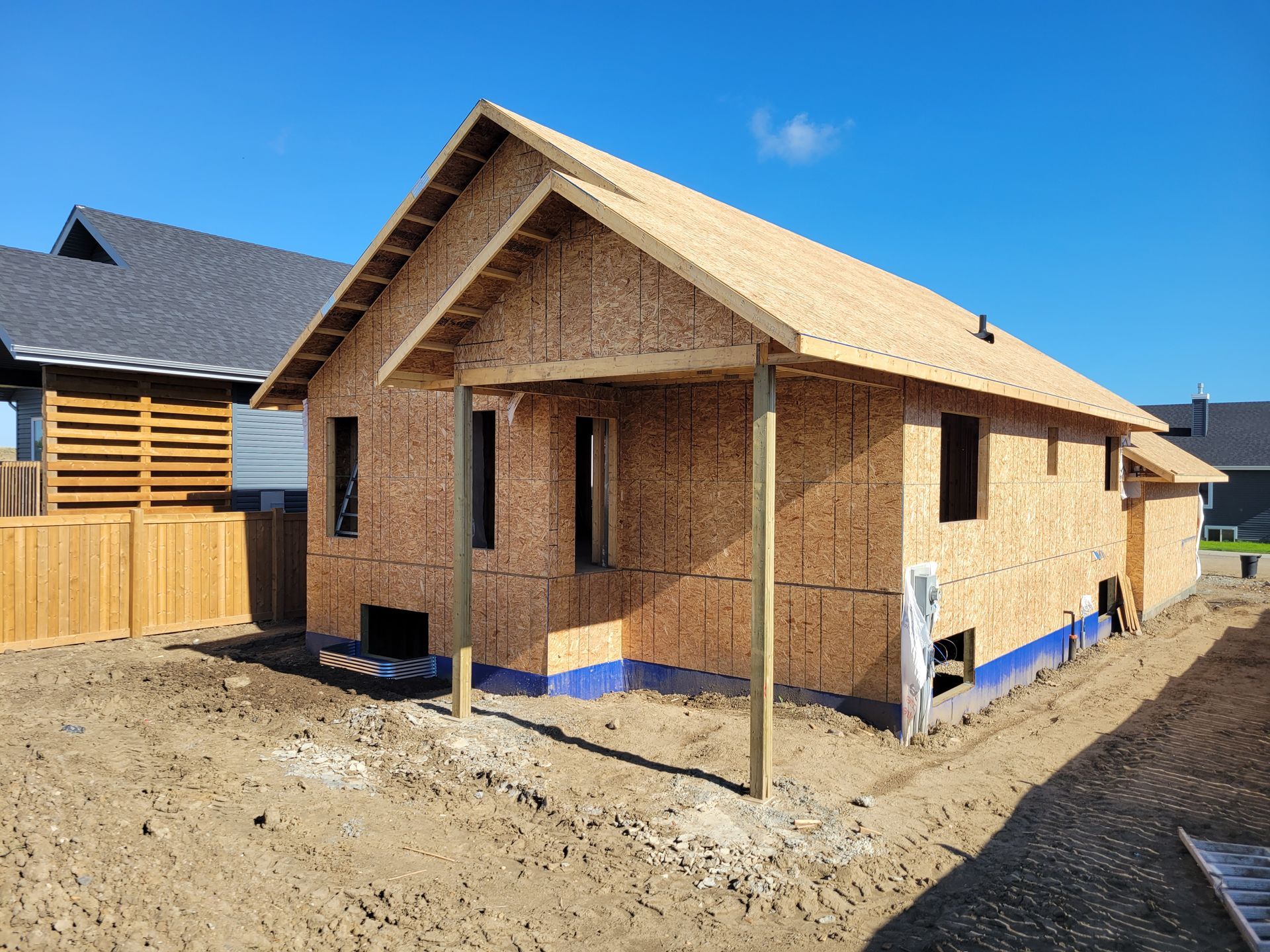 A small wooden house is being built in a backyard.