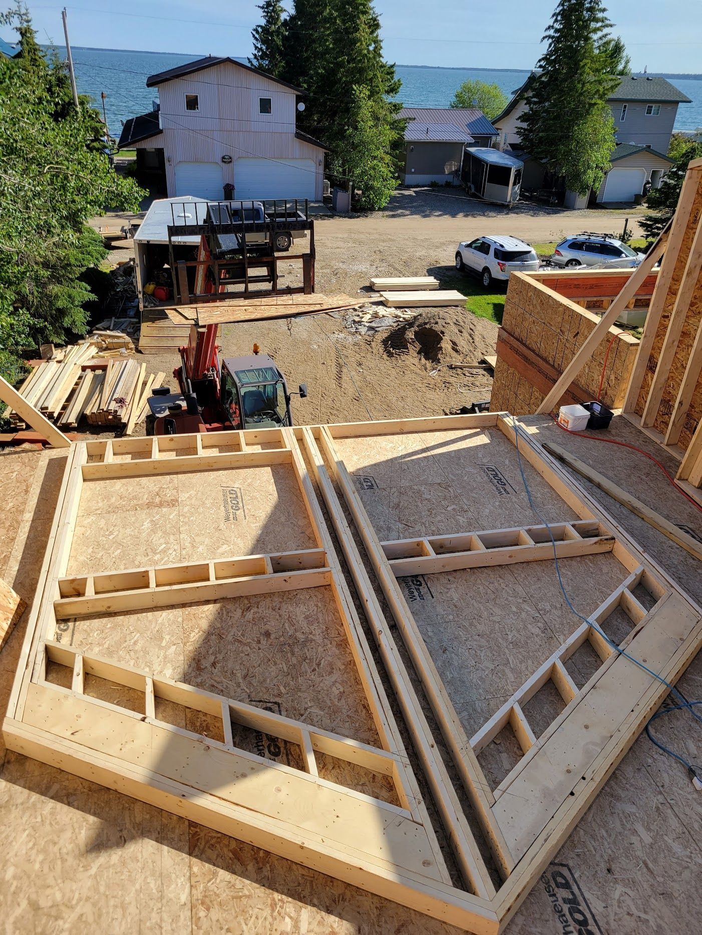 A wooden structure is being built on top of a roof.