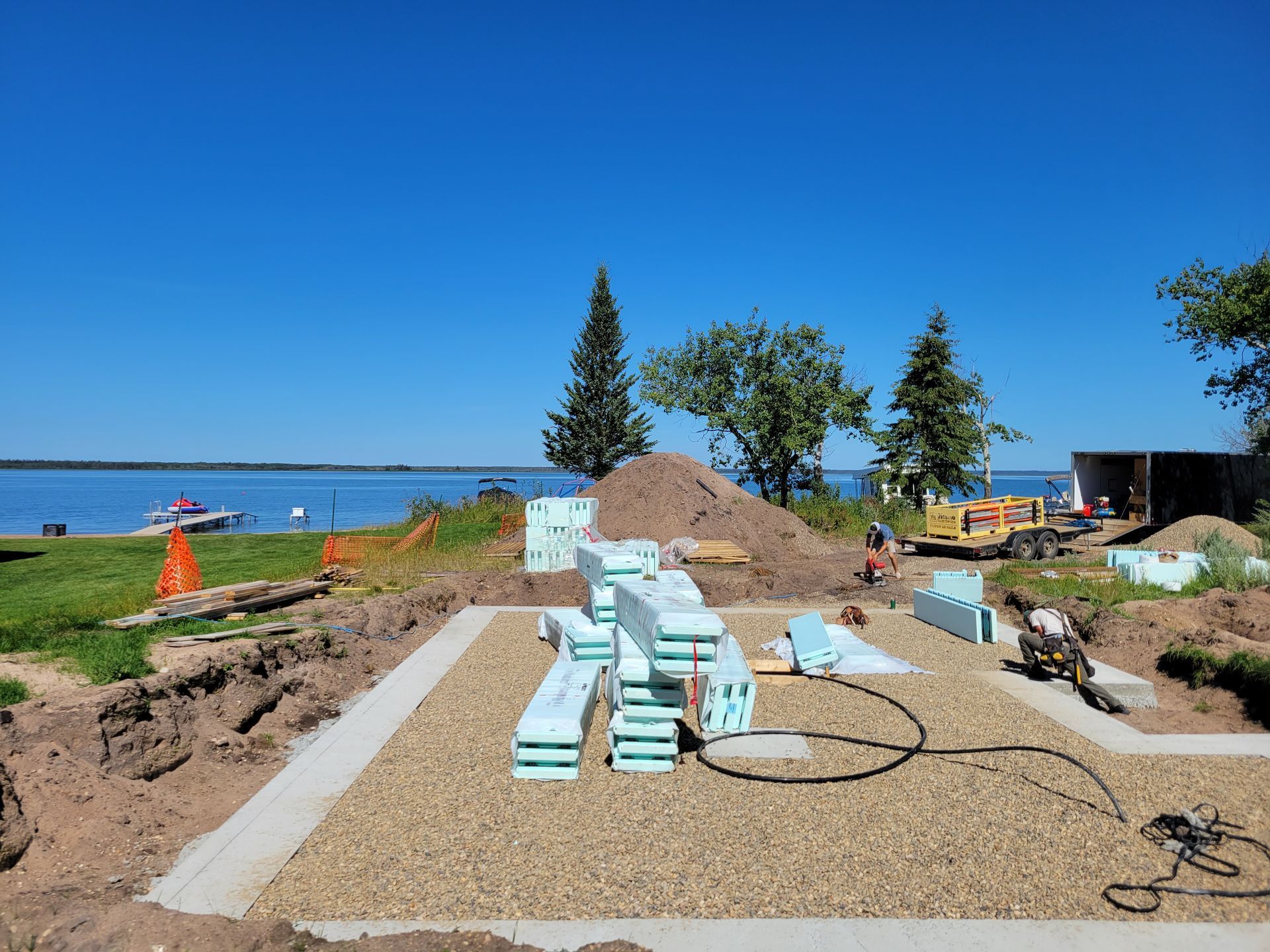 A house is being built on the shore of a lake.