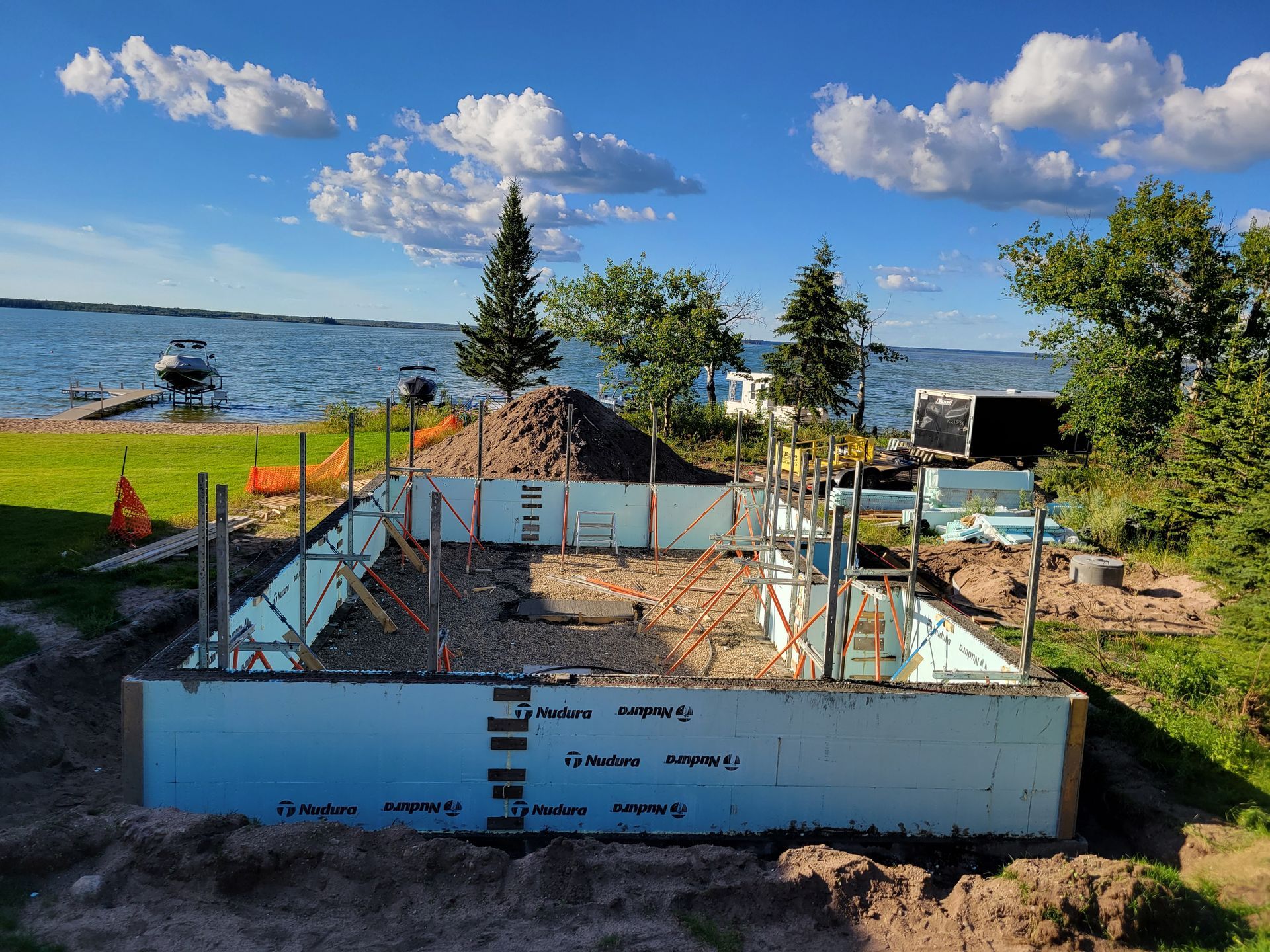 A house is being built on the shore of a lake