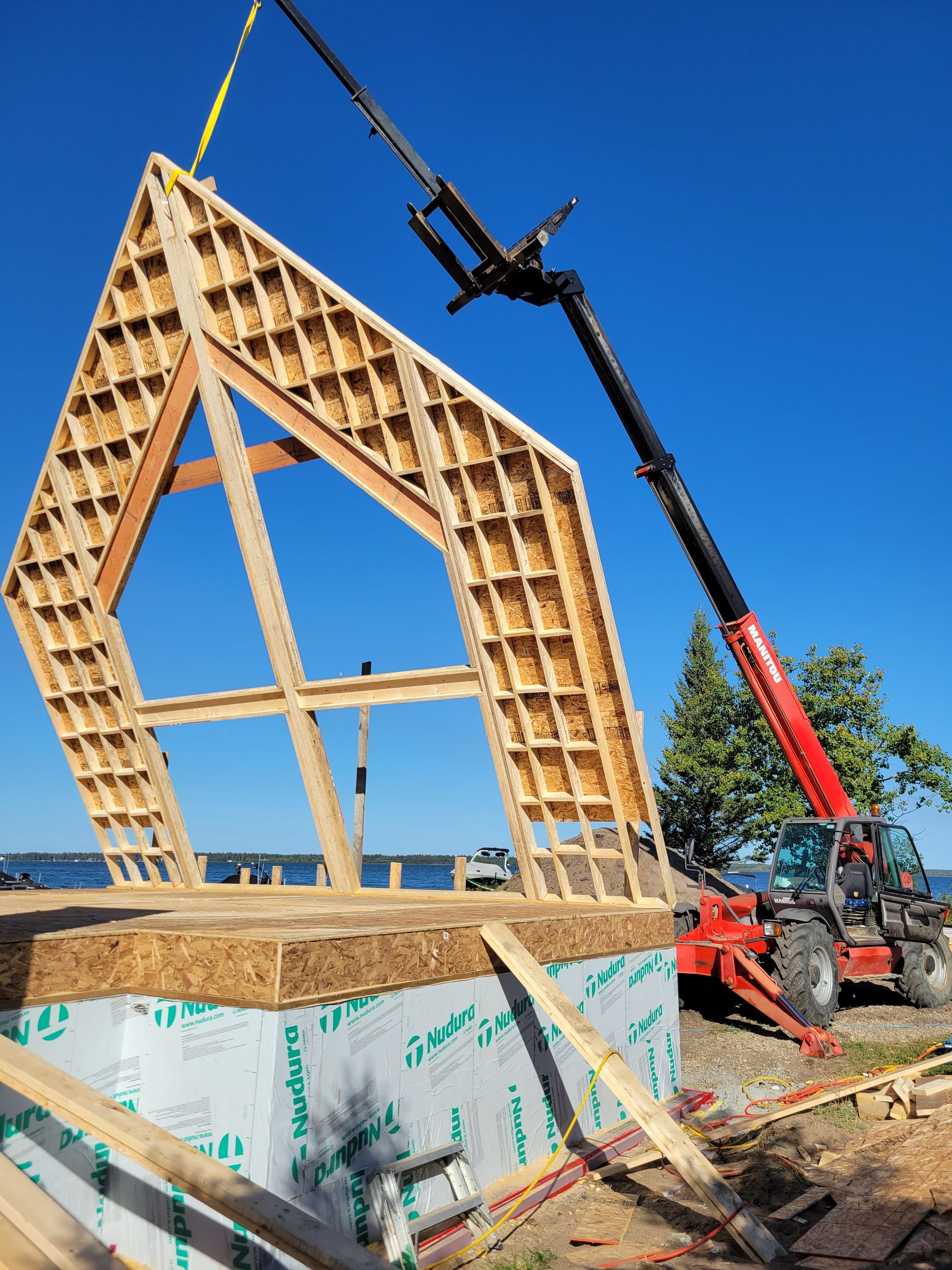 A crane is lifting a large piece of wood