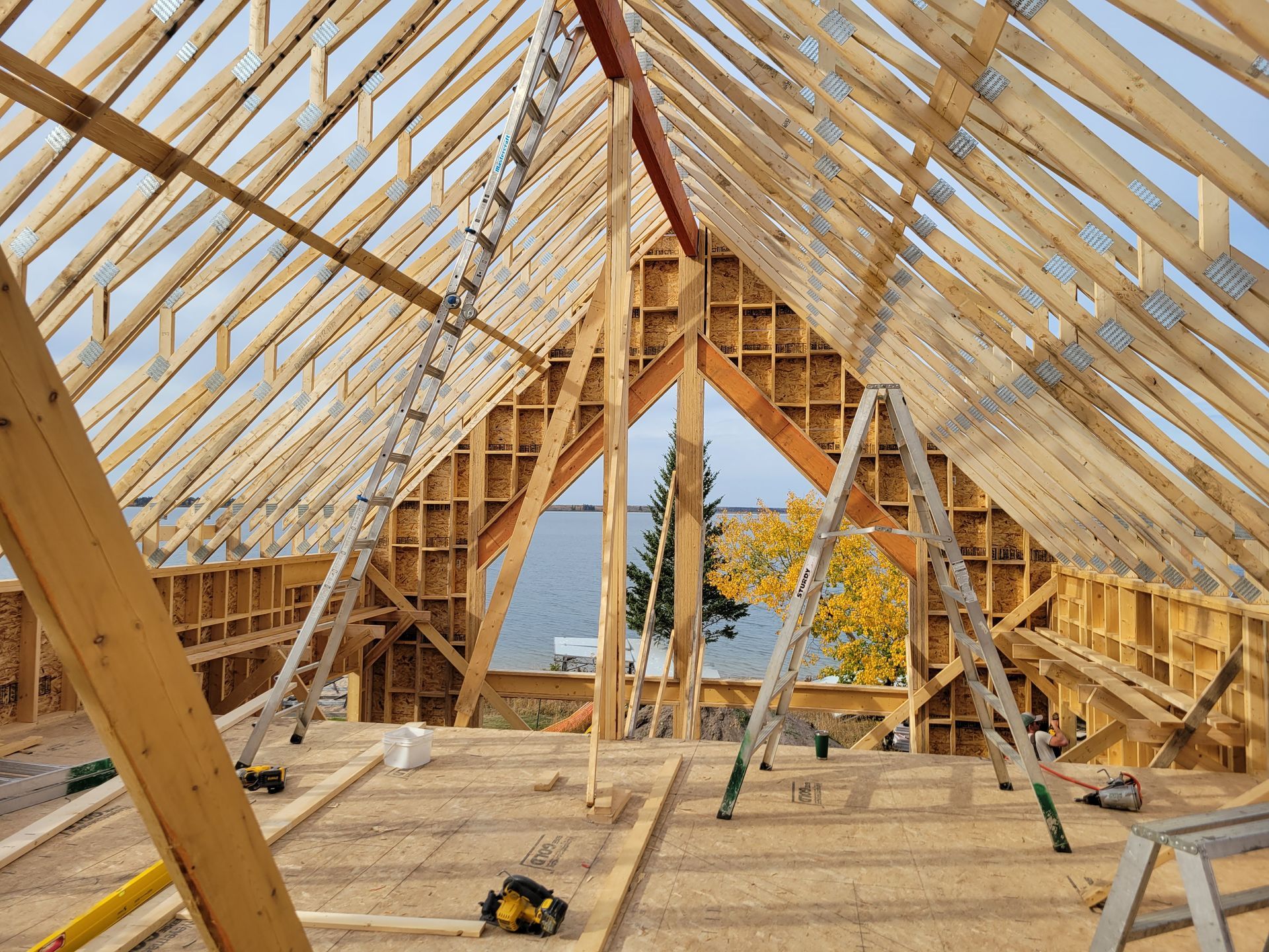 The roof of a building is being built with wooden beams.