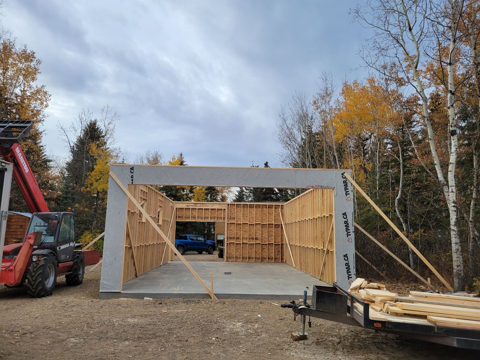 A garage is being built in the middle of a forest.
