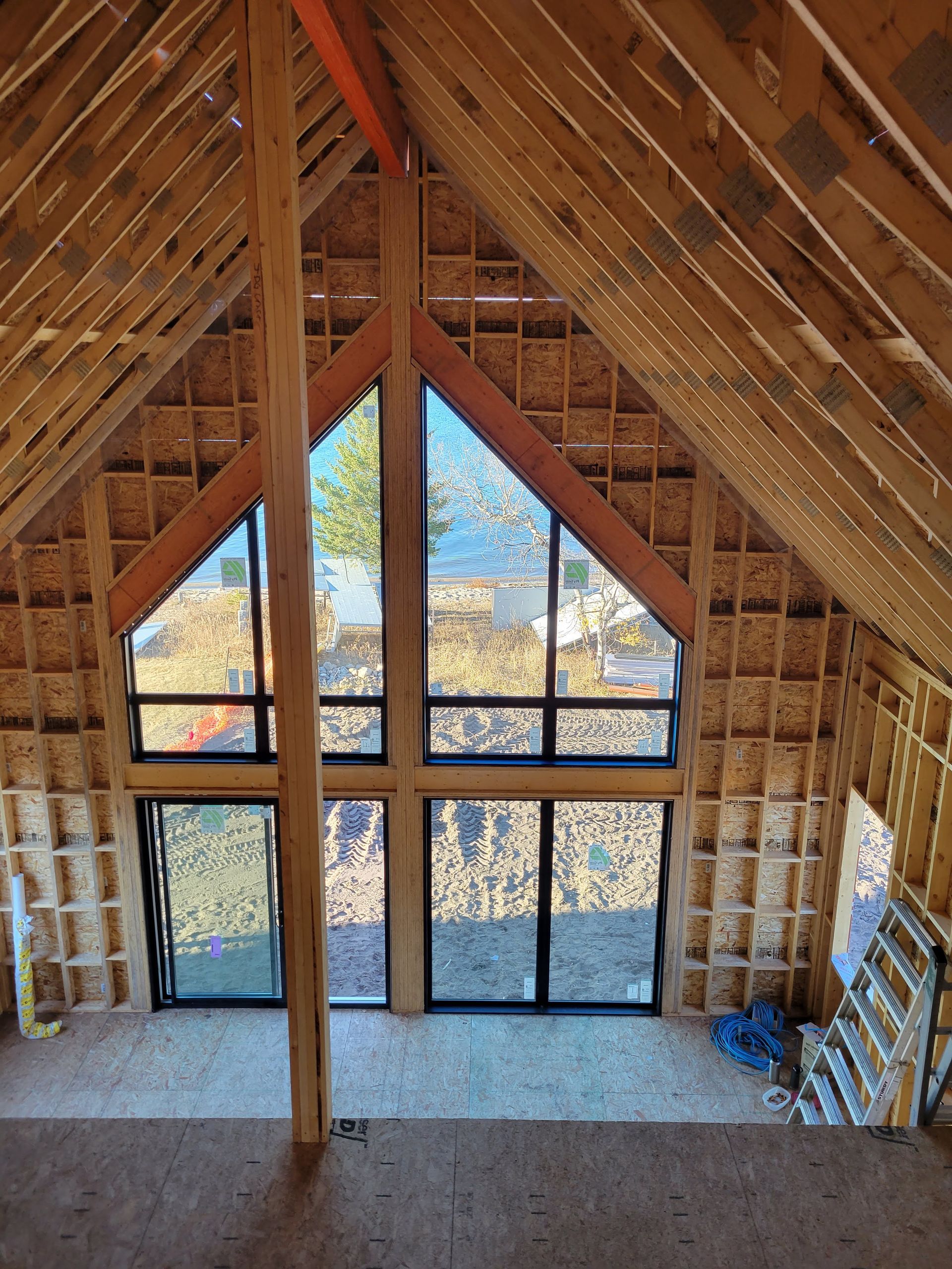 The inside of a house under construction with a lot of windows.
