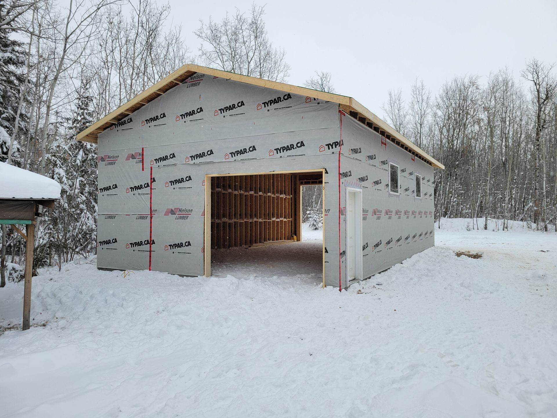 A large building is being built in the snow.