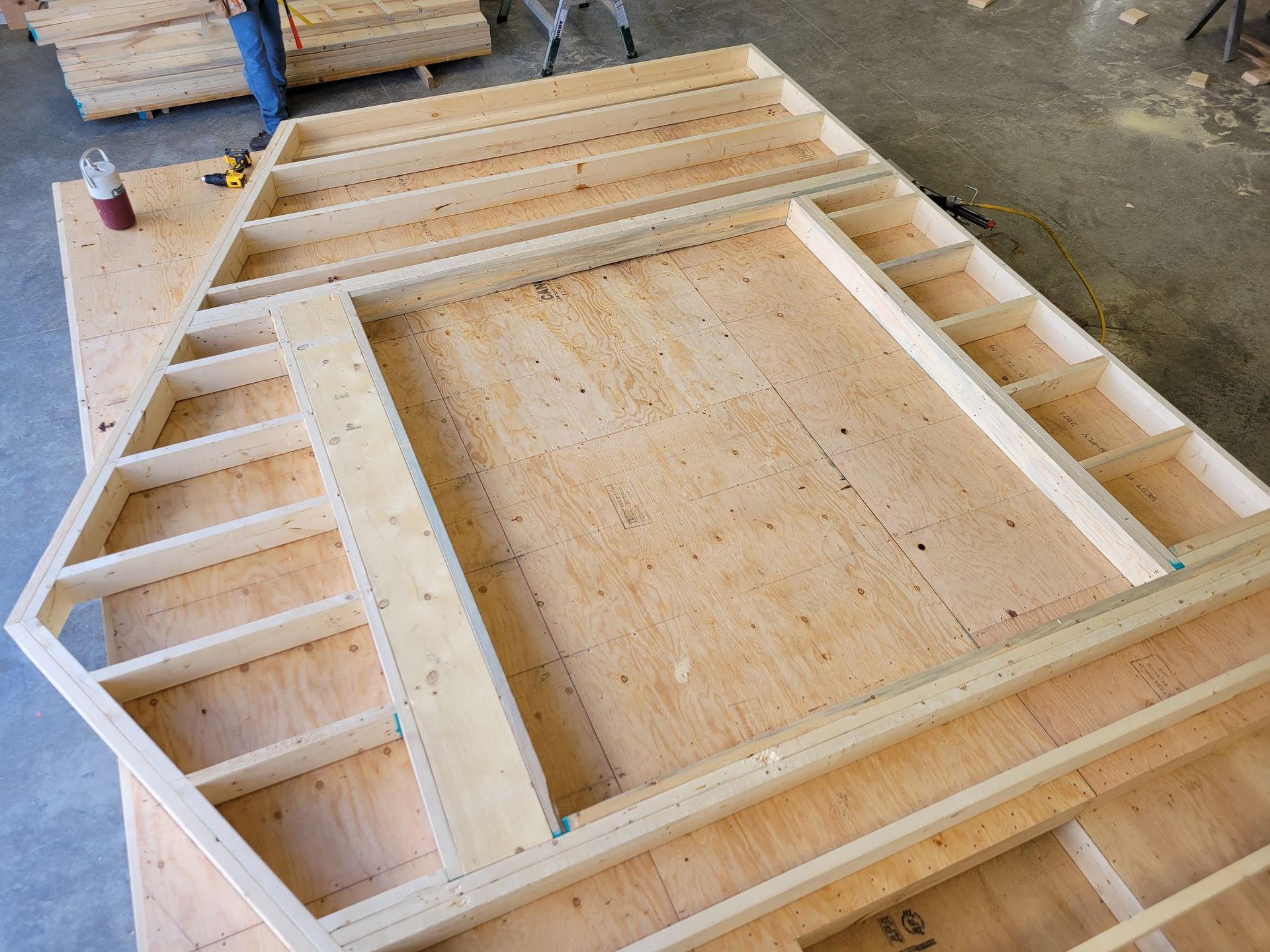 A wooden frame is sitting on top of a wooden table.