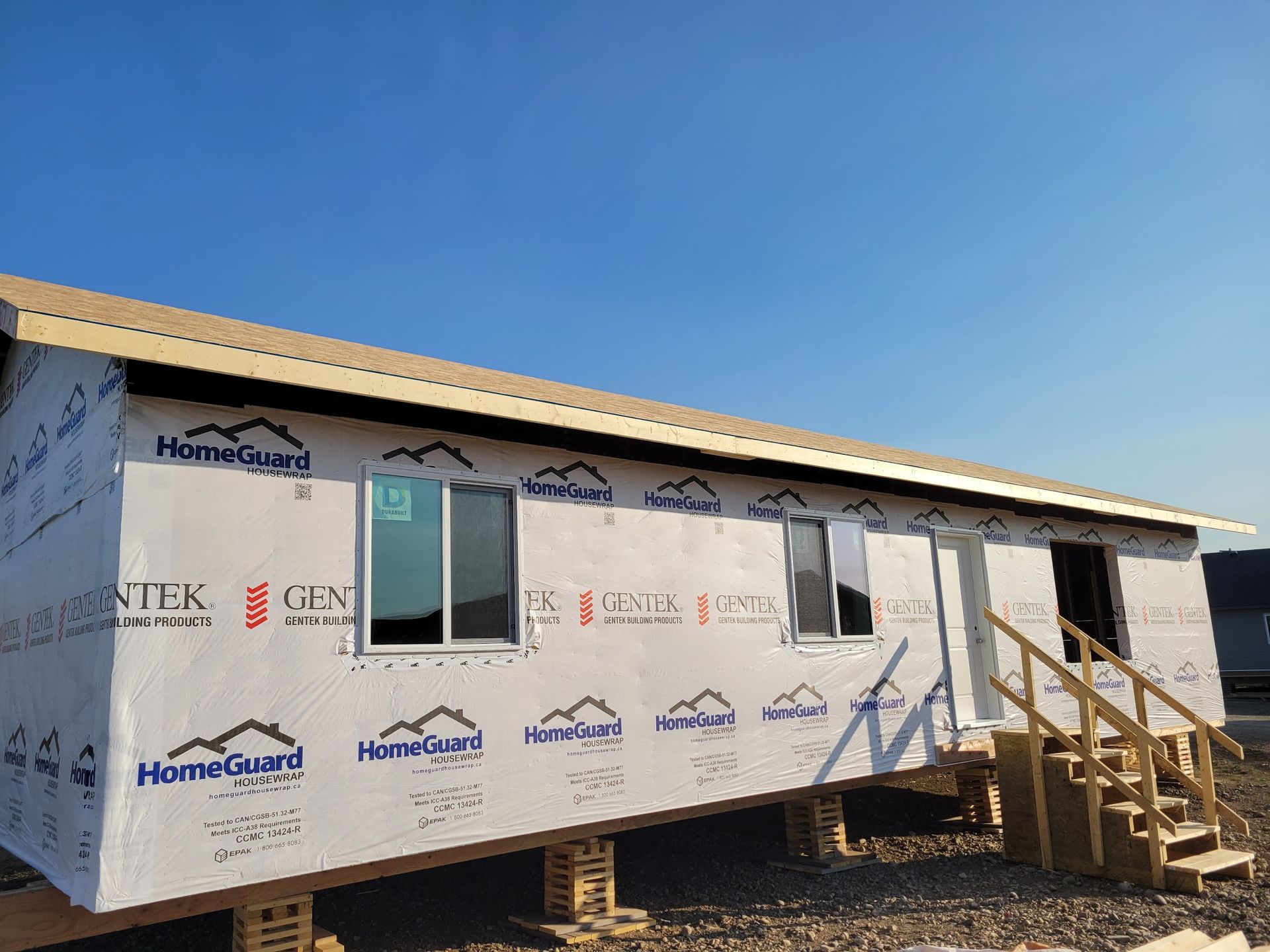 A house with a lot of windows and stairs is being built.