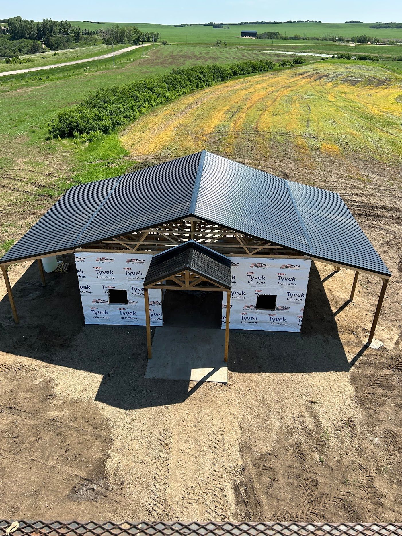 An aerial view of a building under construction in a field.