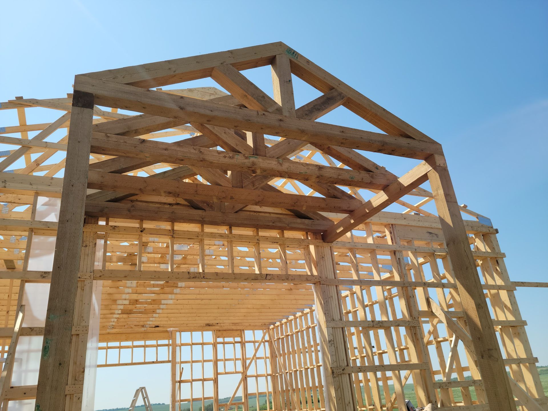 A wooden structure under construction with a blue sky in the background