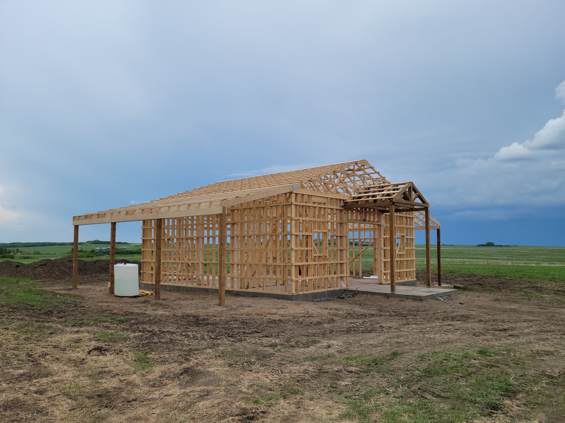 A wooden structure is being built in the middle of a field.