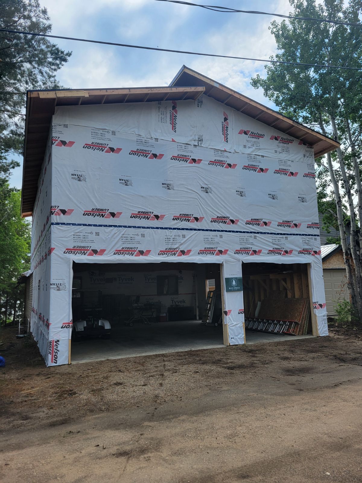 A garage with a car parked in it is being built.