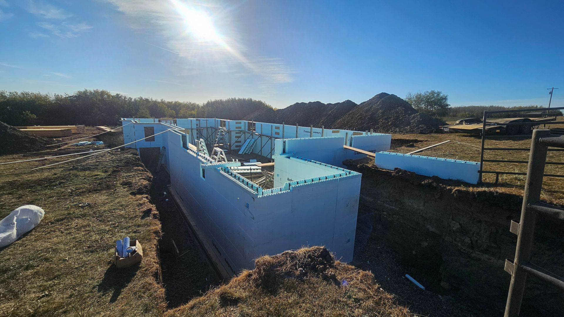 Foundation of a building constructed with insulated concrete forms, outdoors on a sunny day.