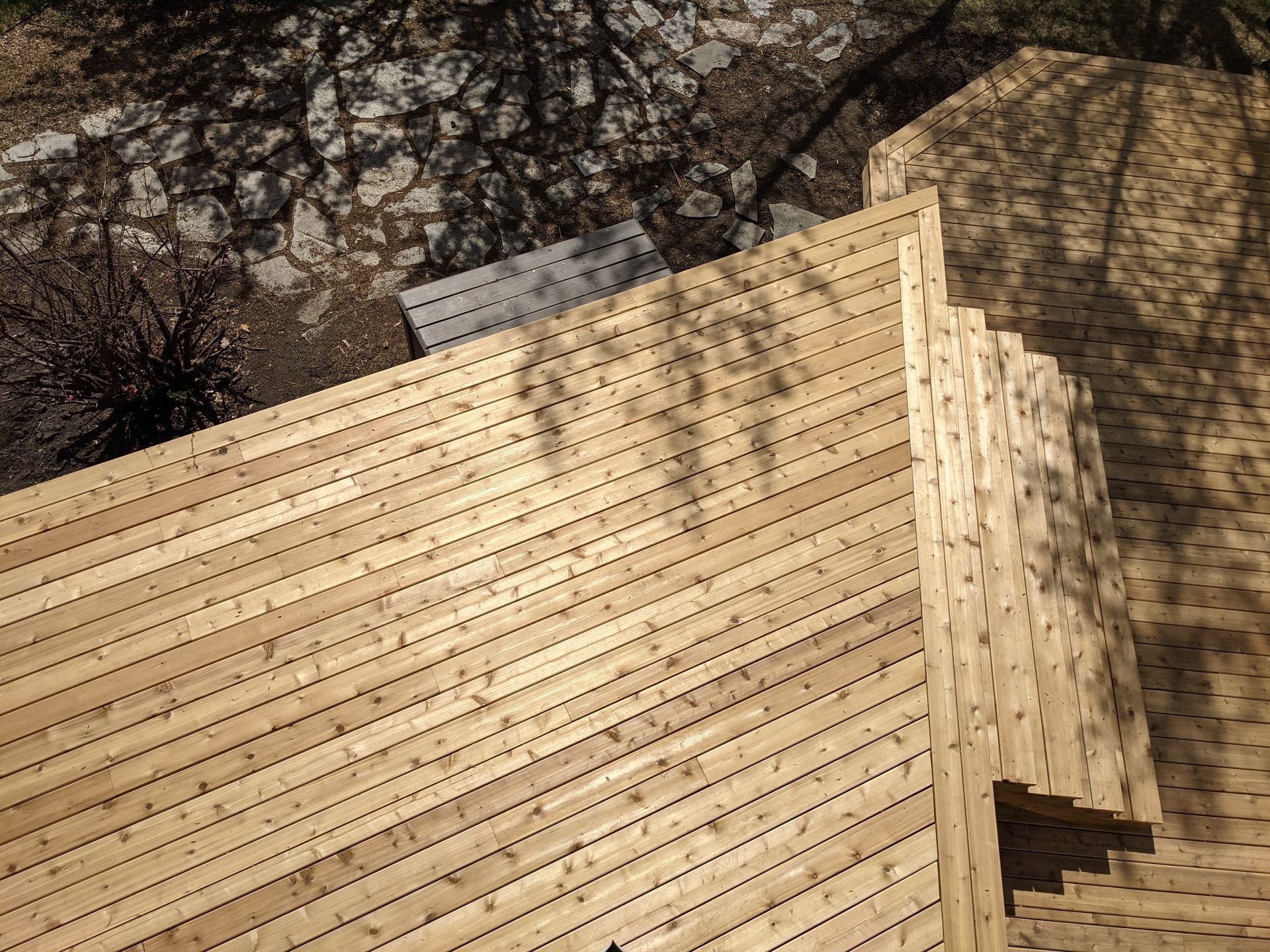 A wooden deck with stairs leading up to it