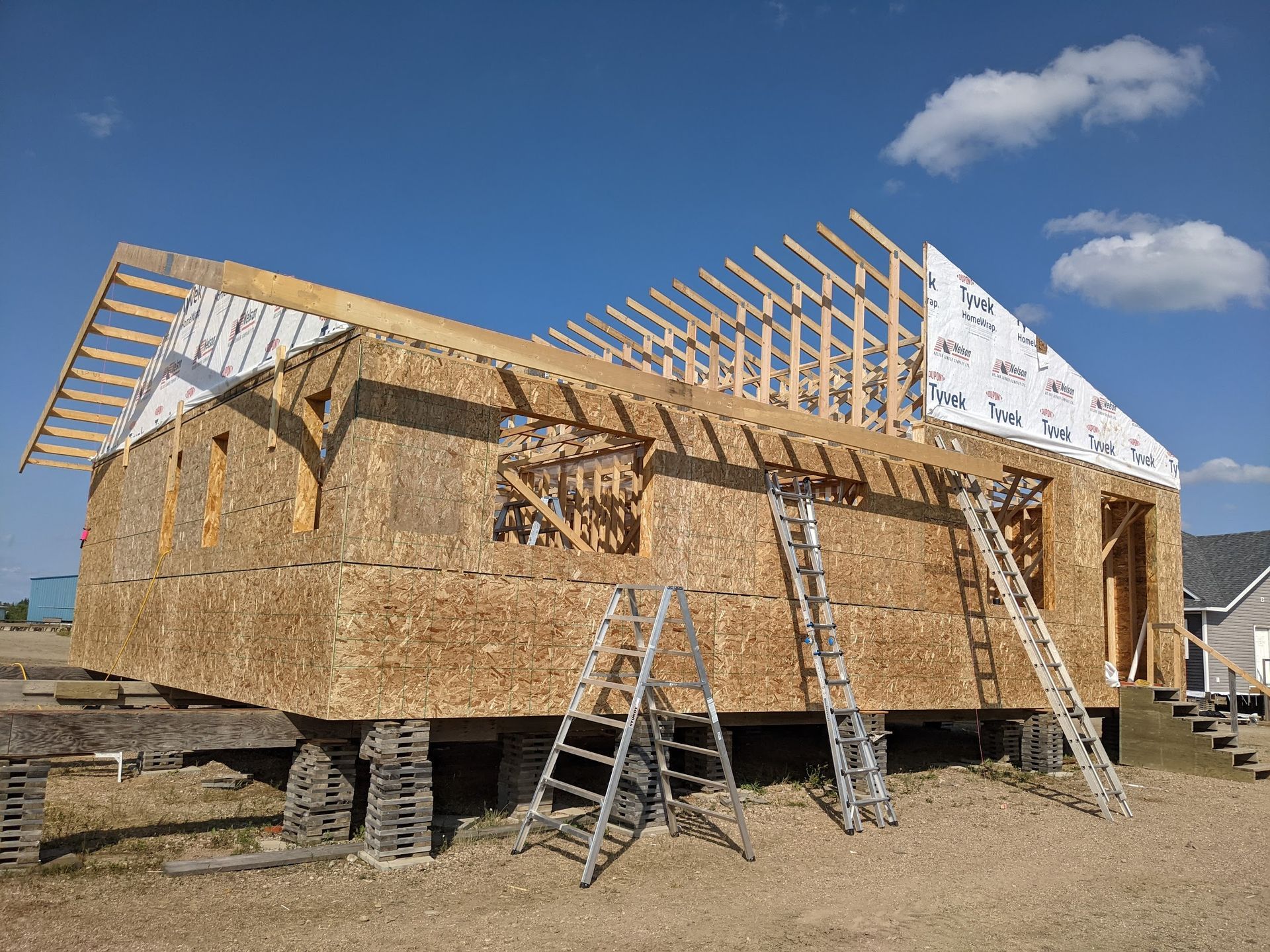 A house that is being built with a blue sky in the background