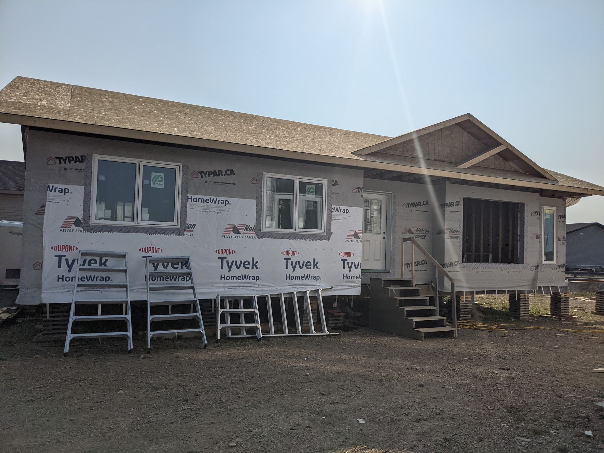 A house is being built on stilts and is covered in styrofoam.