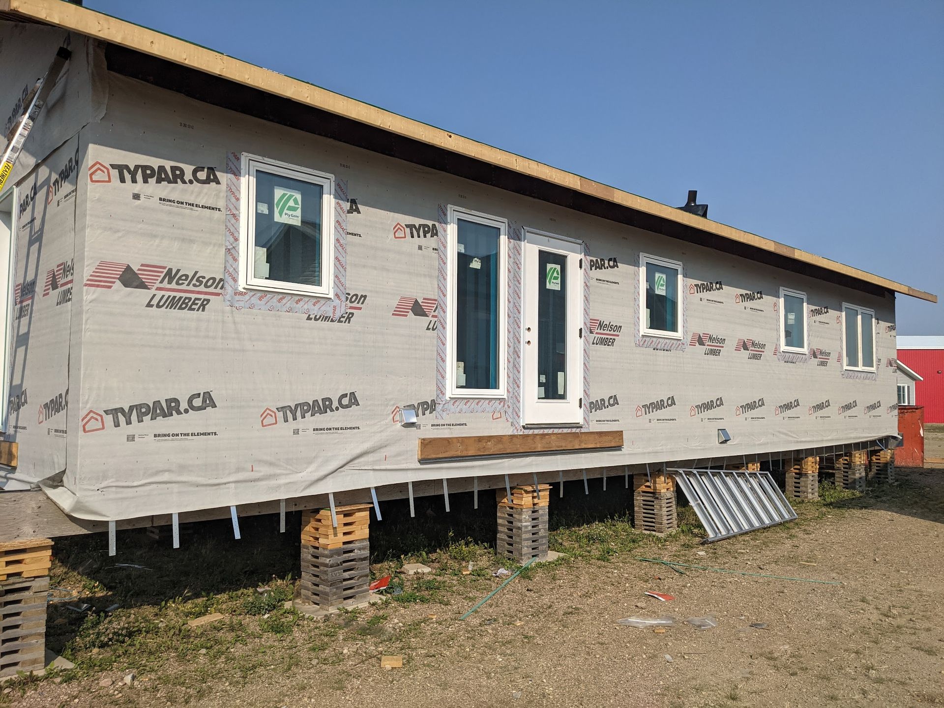 A house is being built on stilts and has styrofoam on the side.