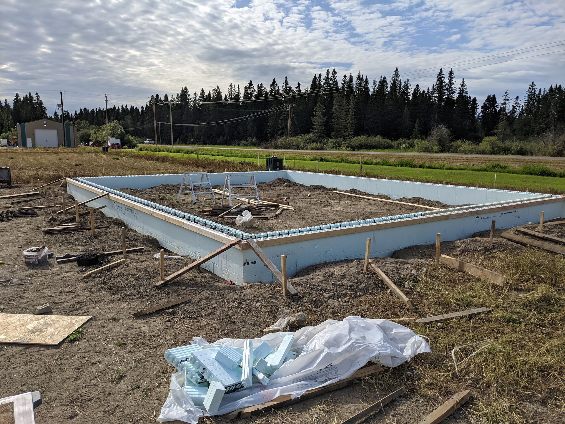A foundation for a house is being built in a field.