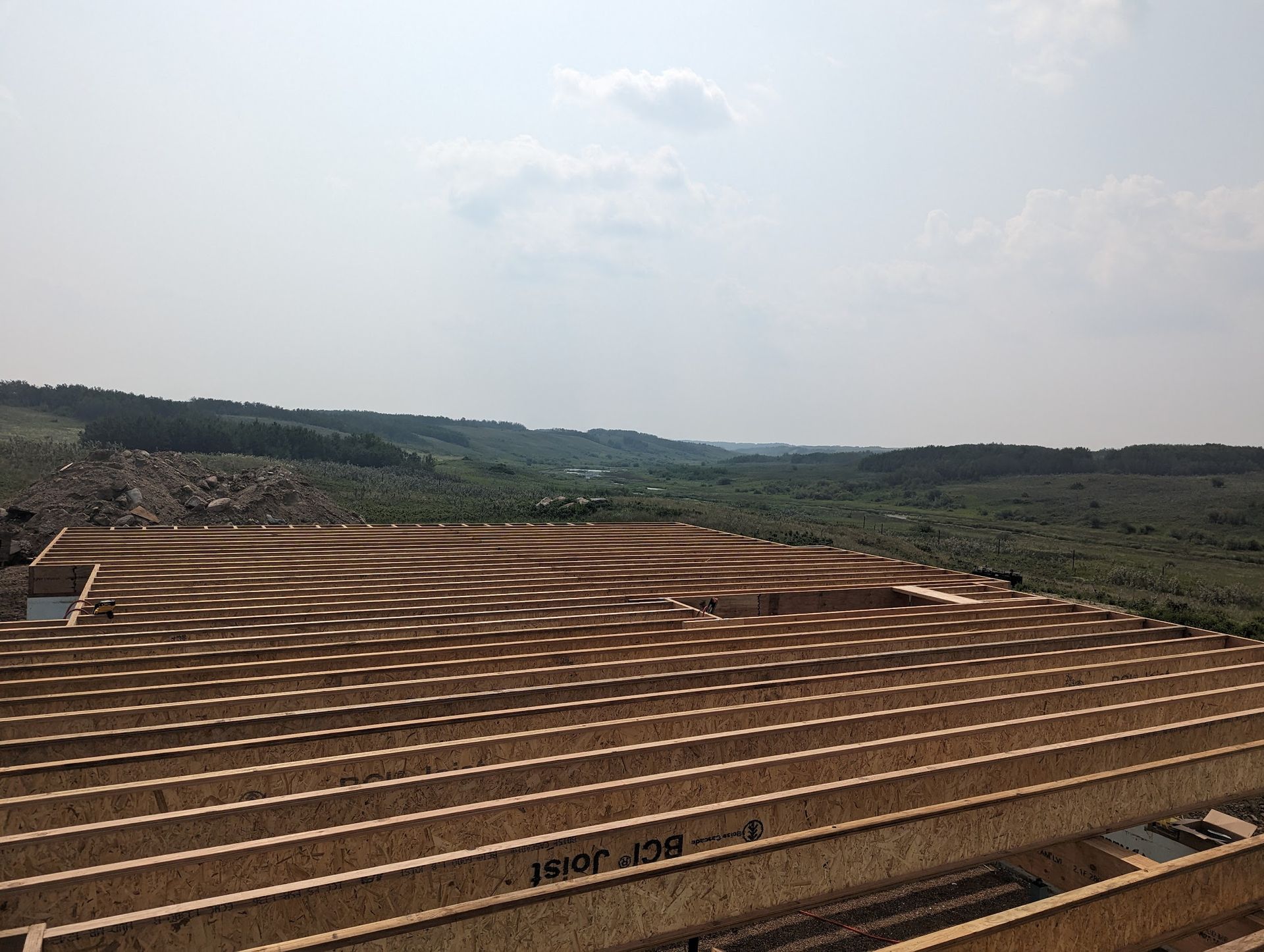 A wooden roof with a view of a valley in the background