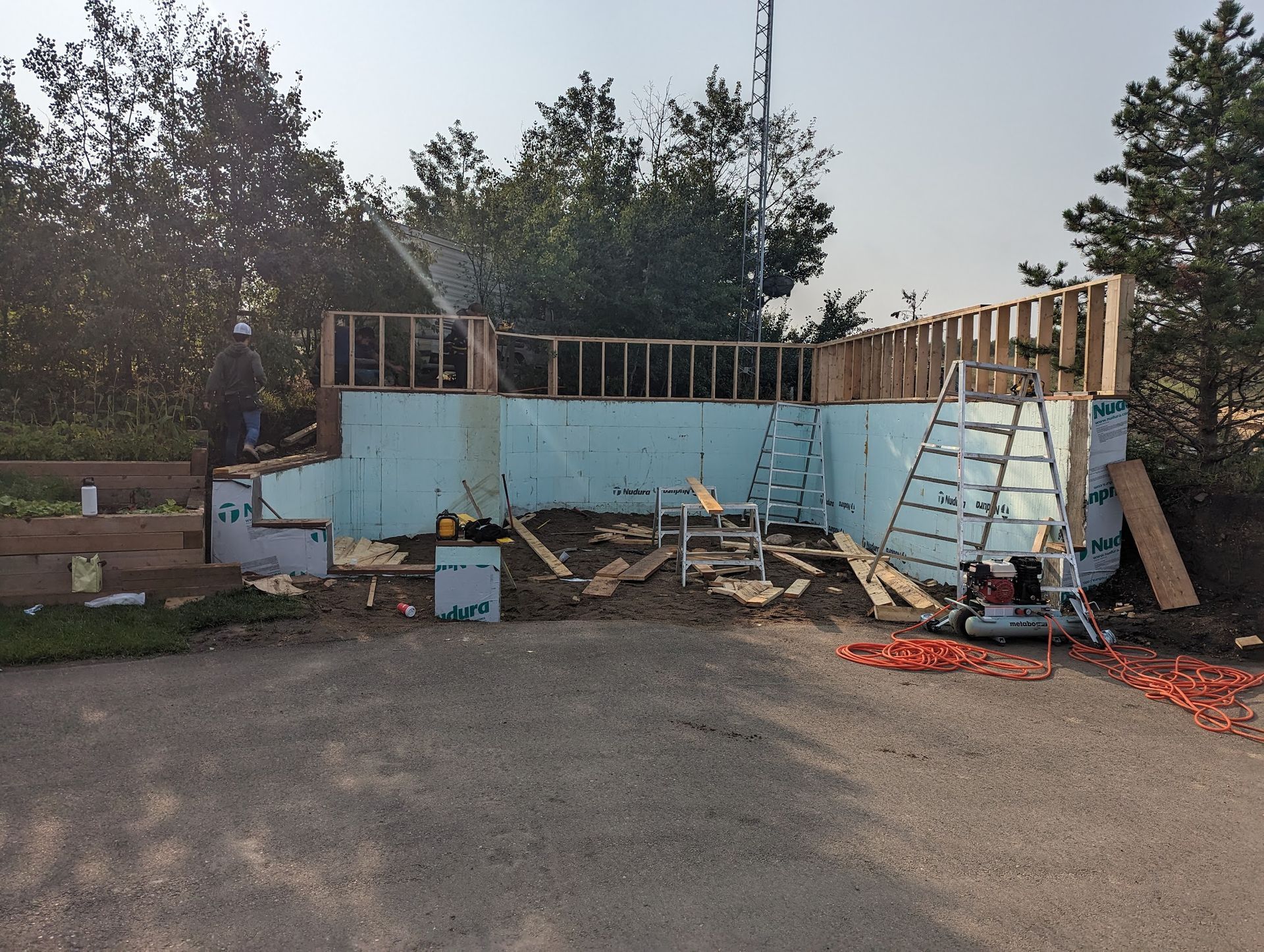 A building is being built in the backyard of a house