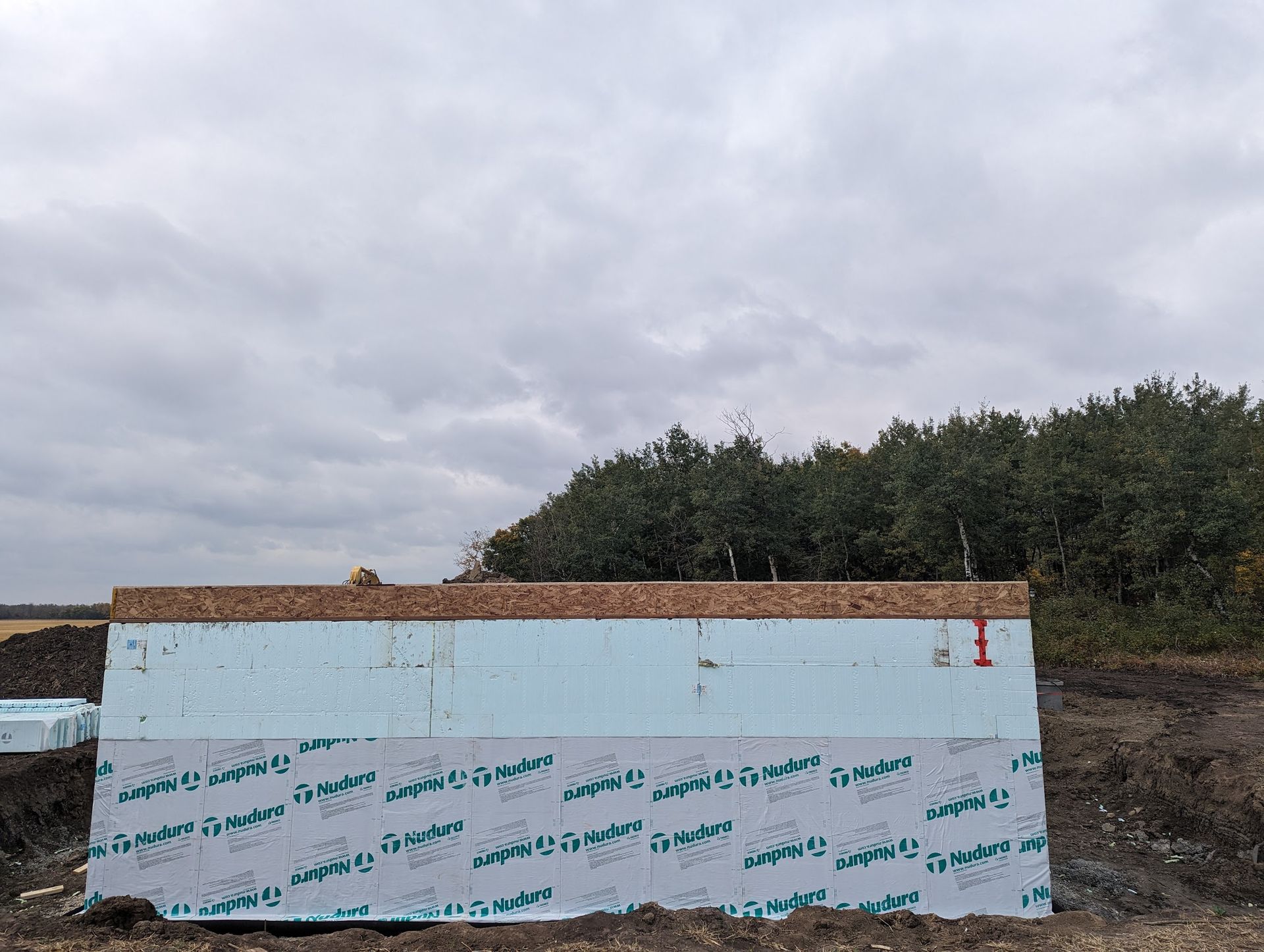 A large block of styrofoam is sitting in the middle of a field.