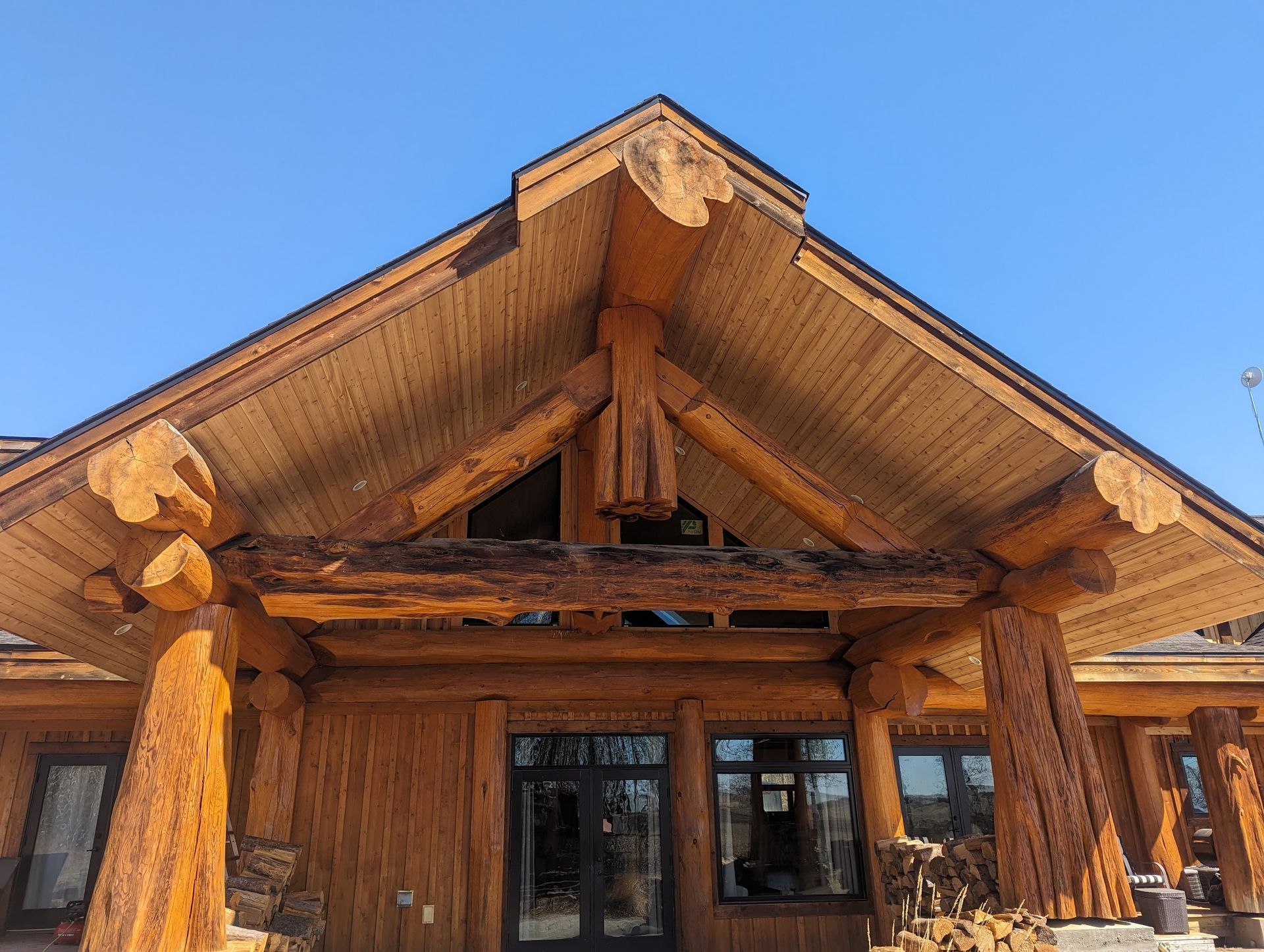 A large wooden building with a blue sky in the background