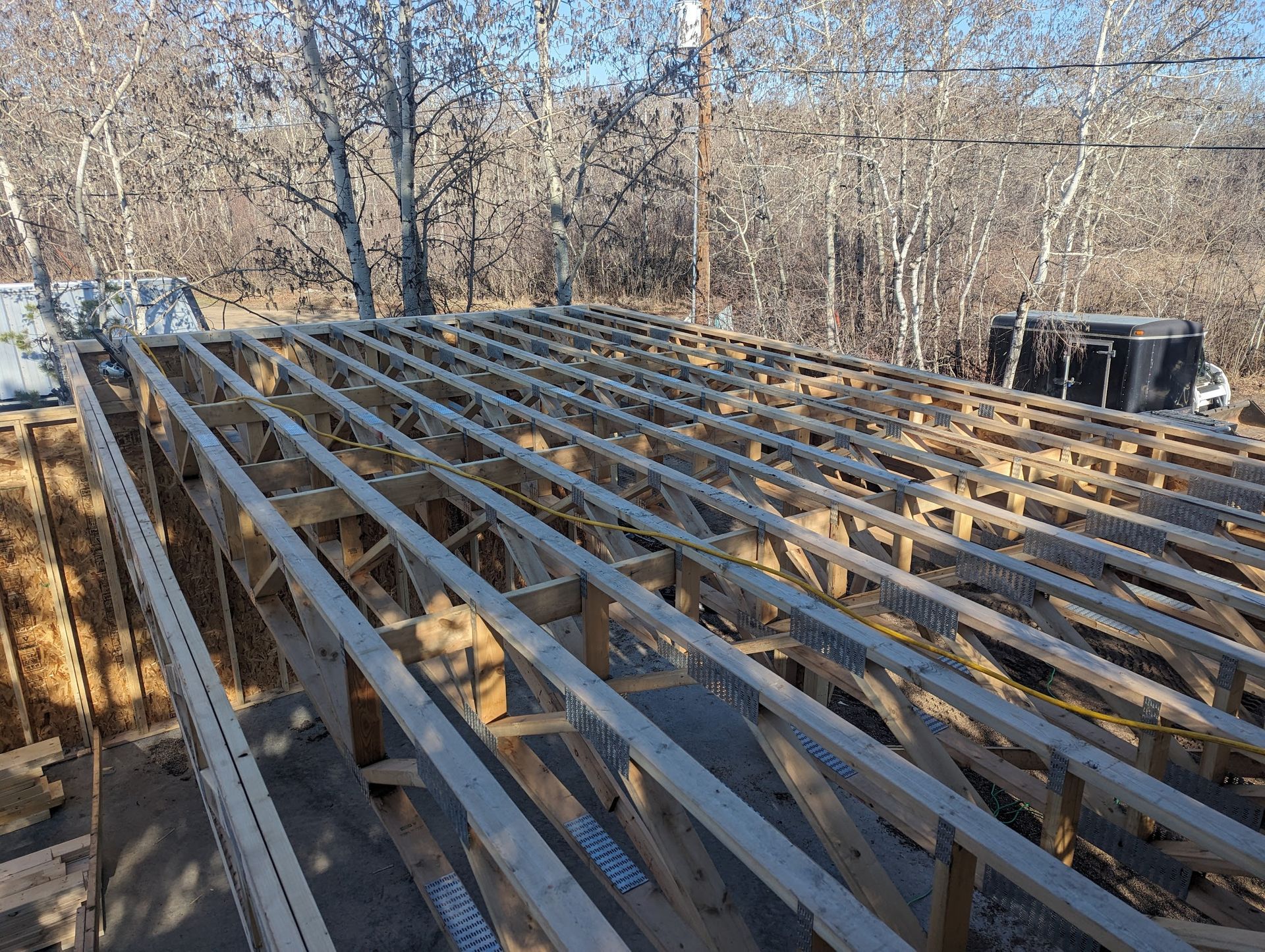 The roof of a building is being built with wooden beams.