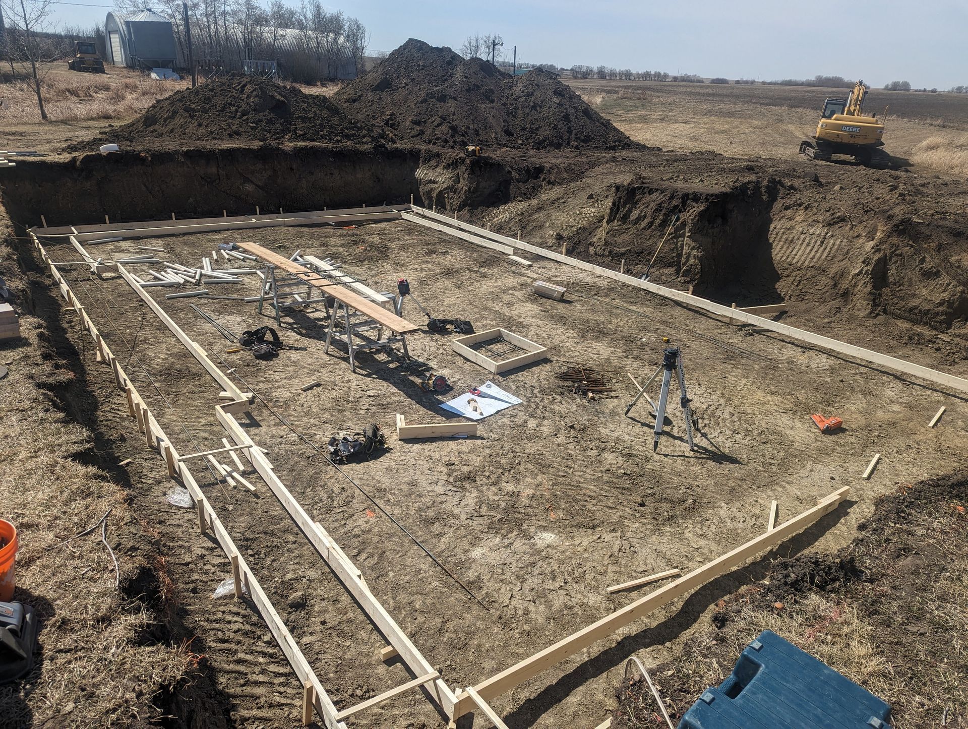 A large pile of dirt is sitting in the middle of a construction site.