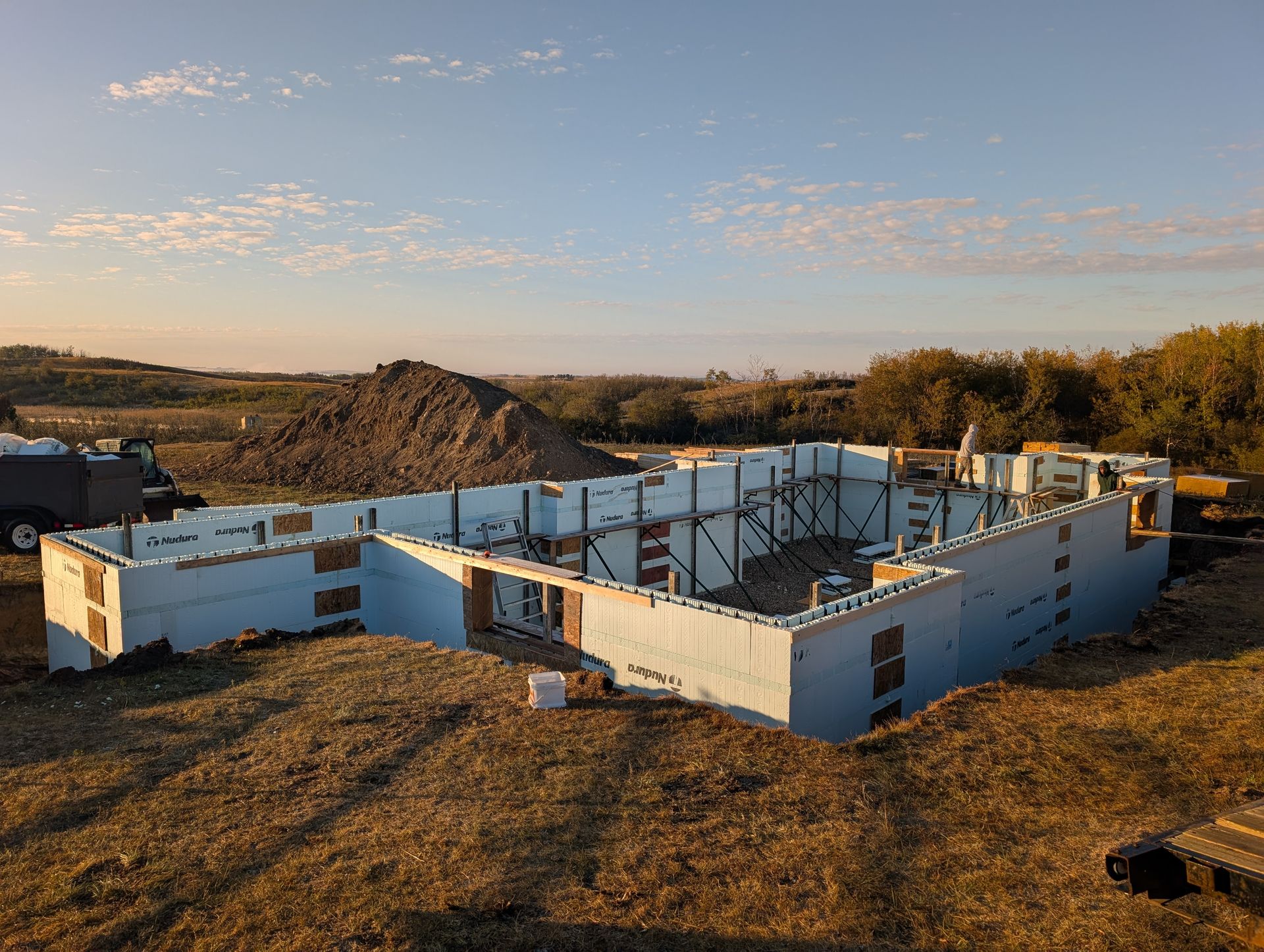 Foundation of a building under construction, made of white foam blocks, outdoors.