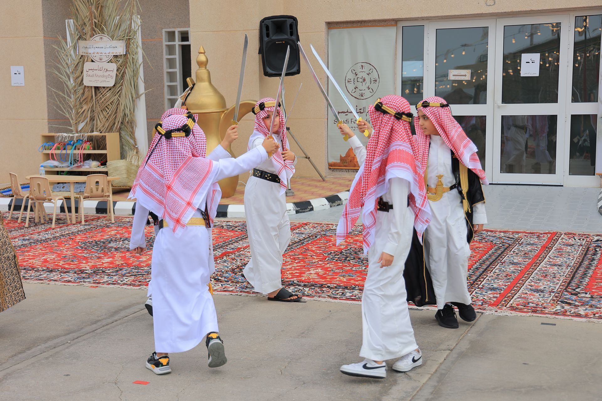 A group of boys are dancing in front of a building