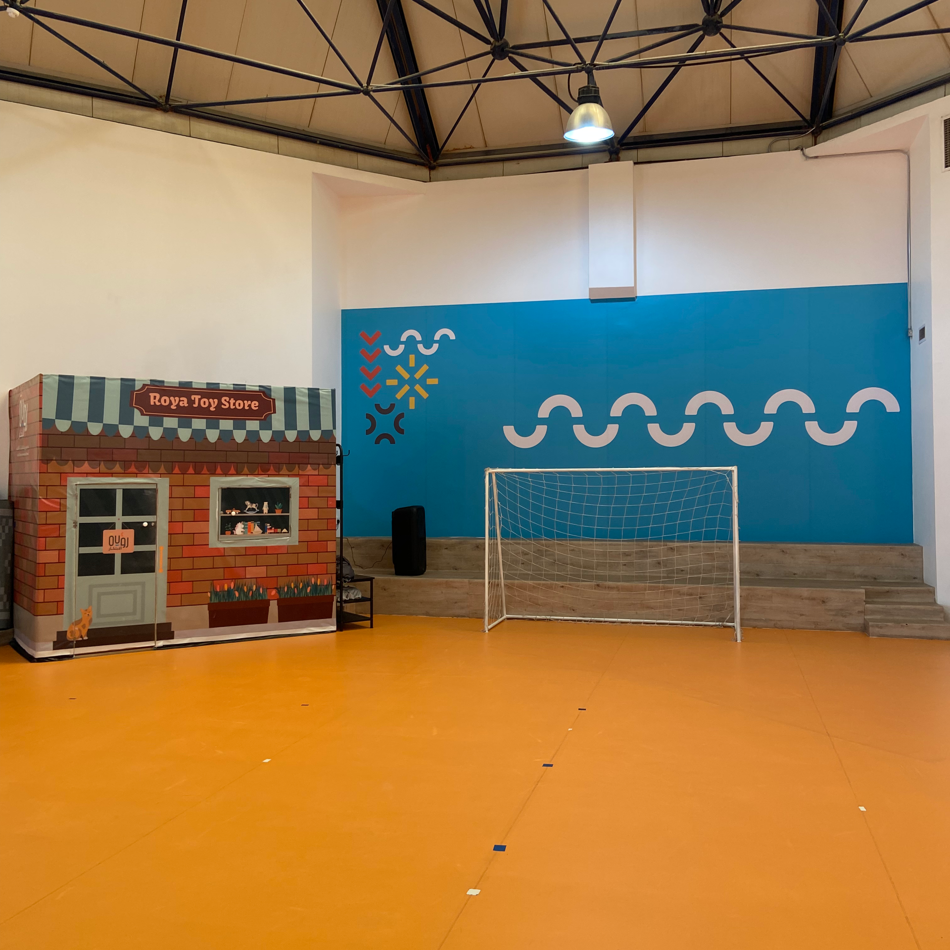 A group of young boys are sitting at a table drawing on papers