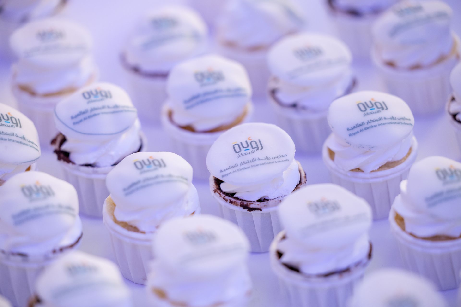 A bunch of cupcakes are sitting on a table.