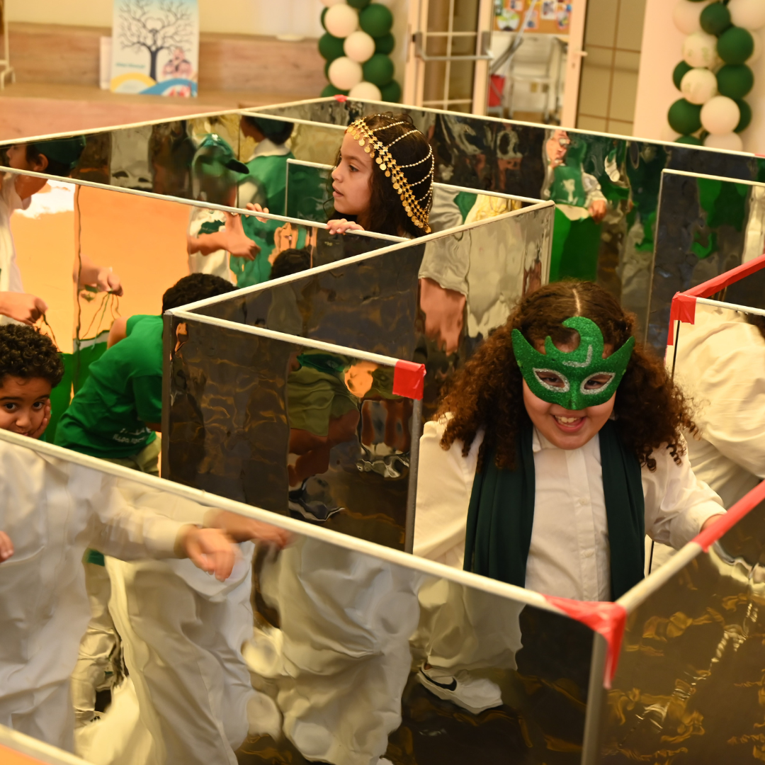 A group of children are playing in a mirrored maze