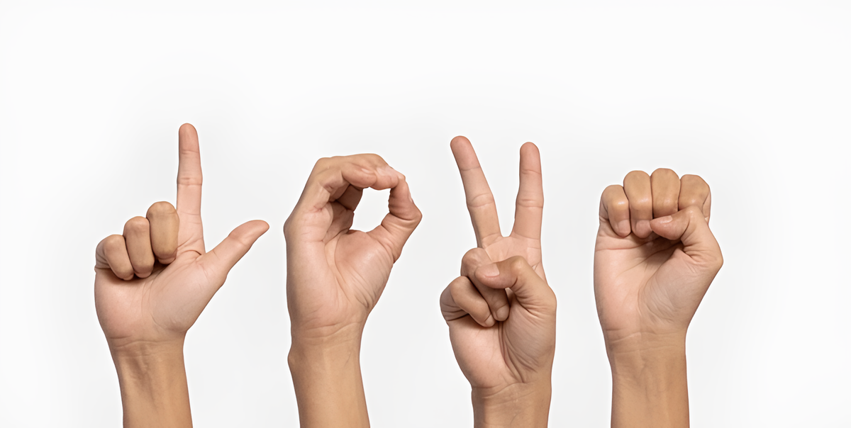A group of hands making the word love in sign language.