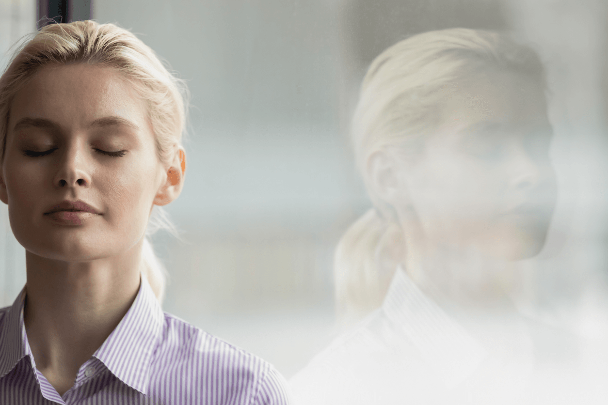 woman breathing with her eyes closed to calm down