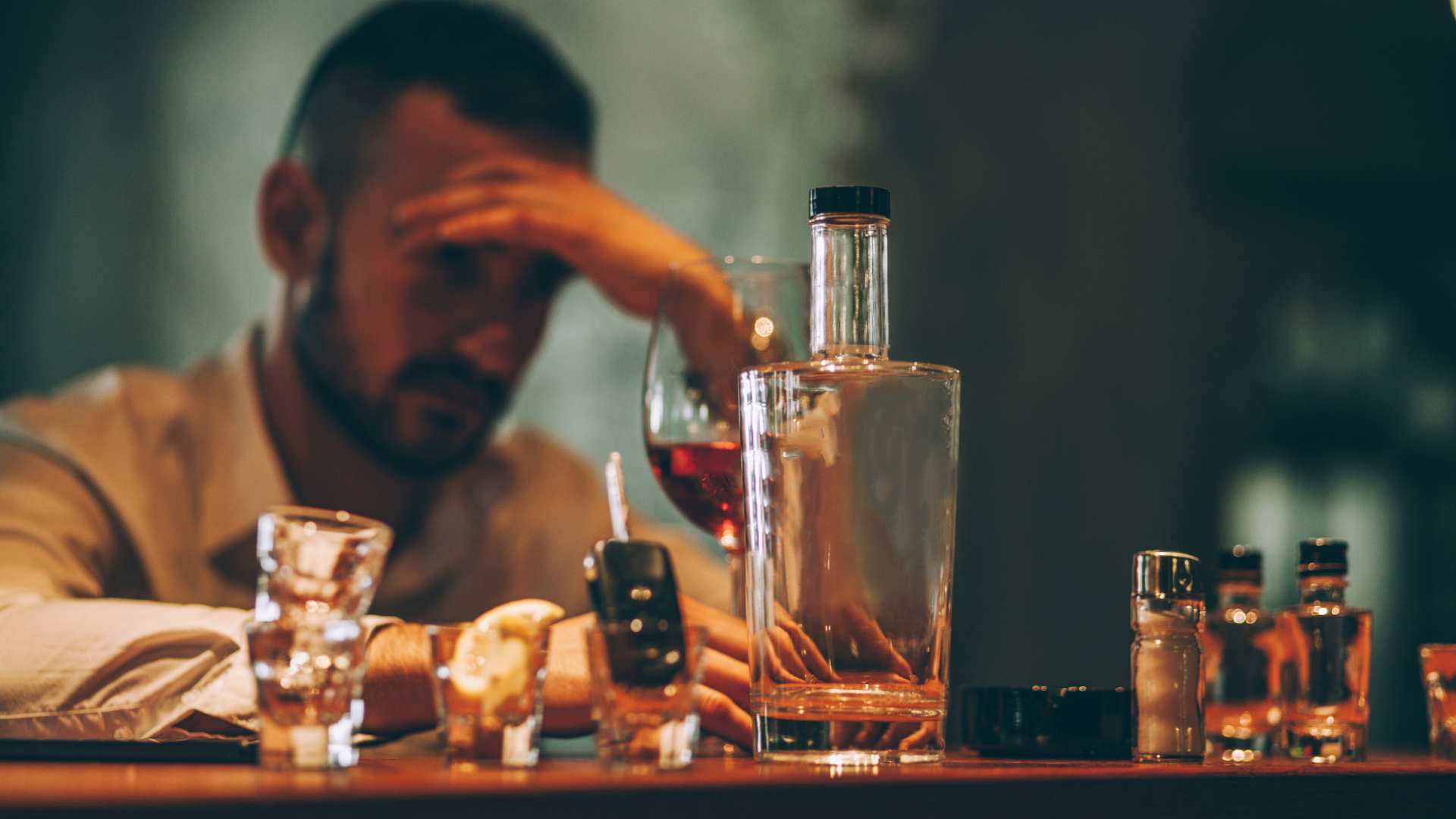 Picture of man drinking at a bar because he suffers from emotional abuse