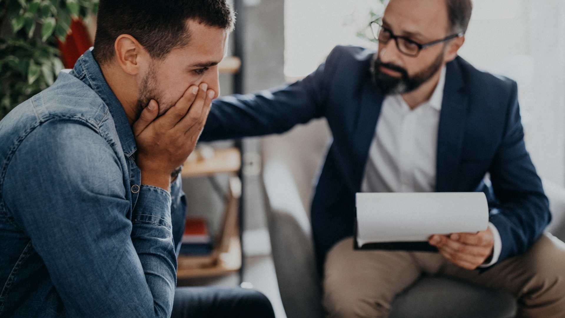 anxious man being comforted by his Psychiatrist 