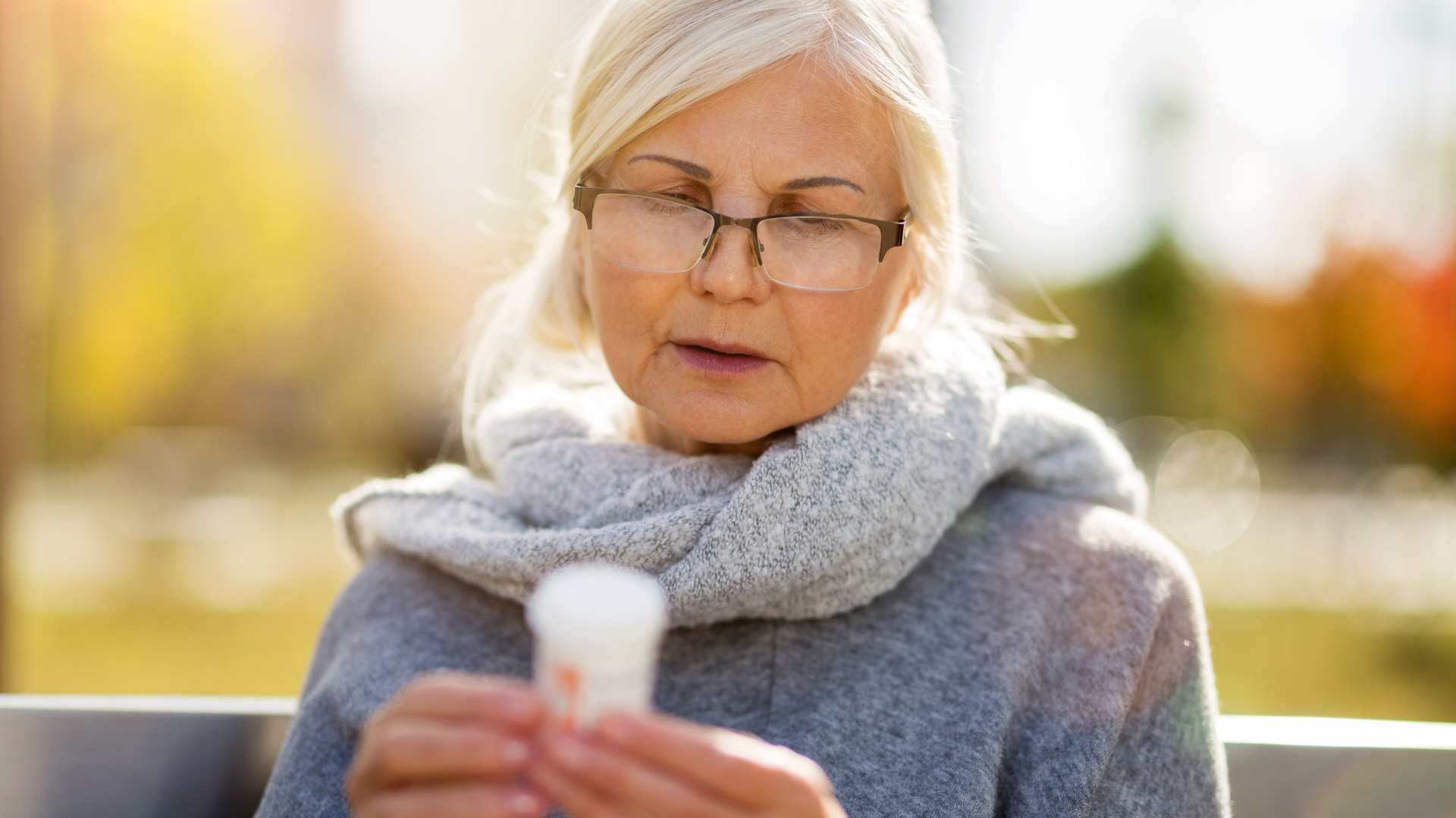 Old woman trying to manage her medications