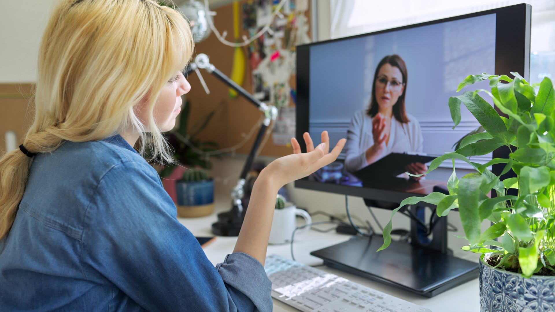 woman in front of a monitor speaking to a psychiatrist veritally