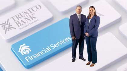 A man and woman in business attire stand on a keyboard key labeled 