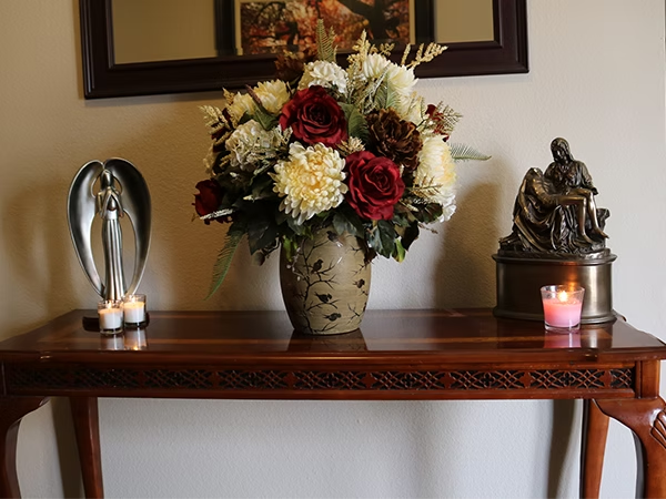 Black butterfly with white markings on a green leaf.