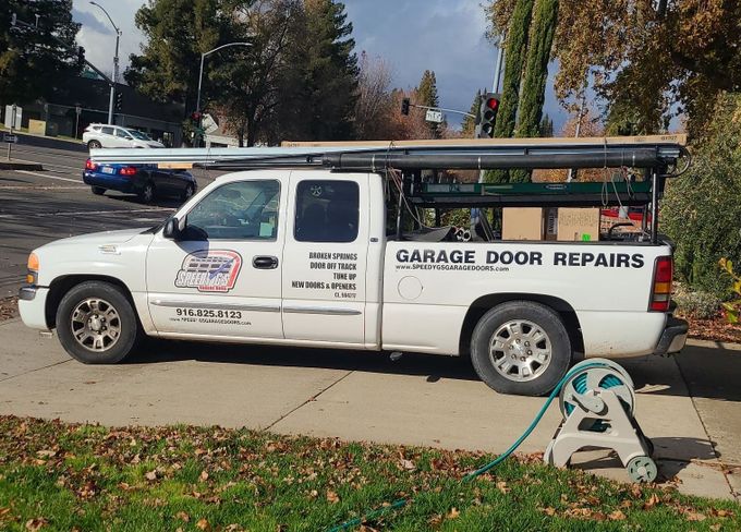 a white truck that says garage door repairs on the side